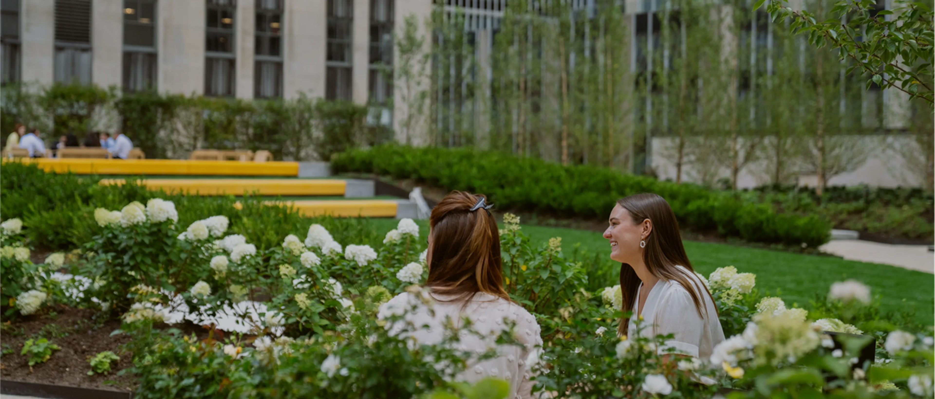 Two women sitting in a garden