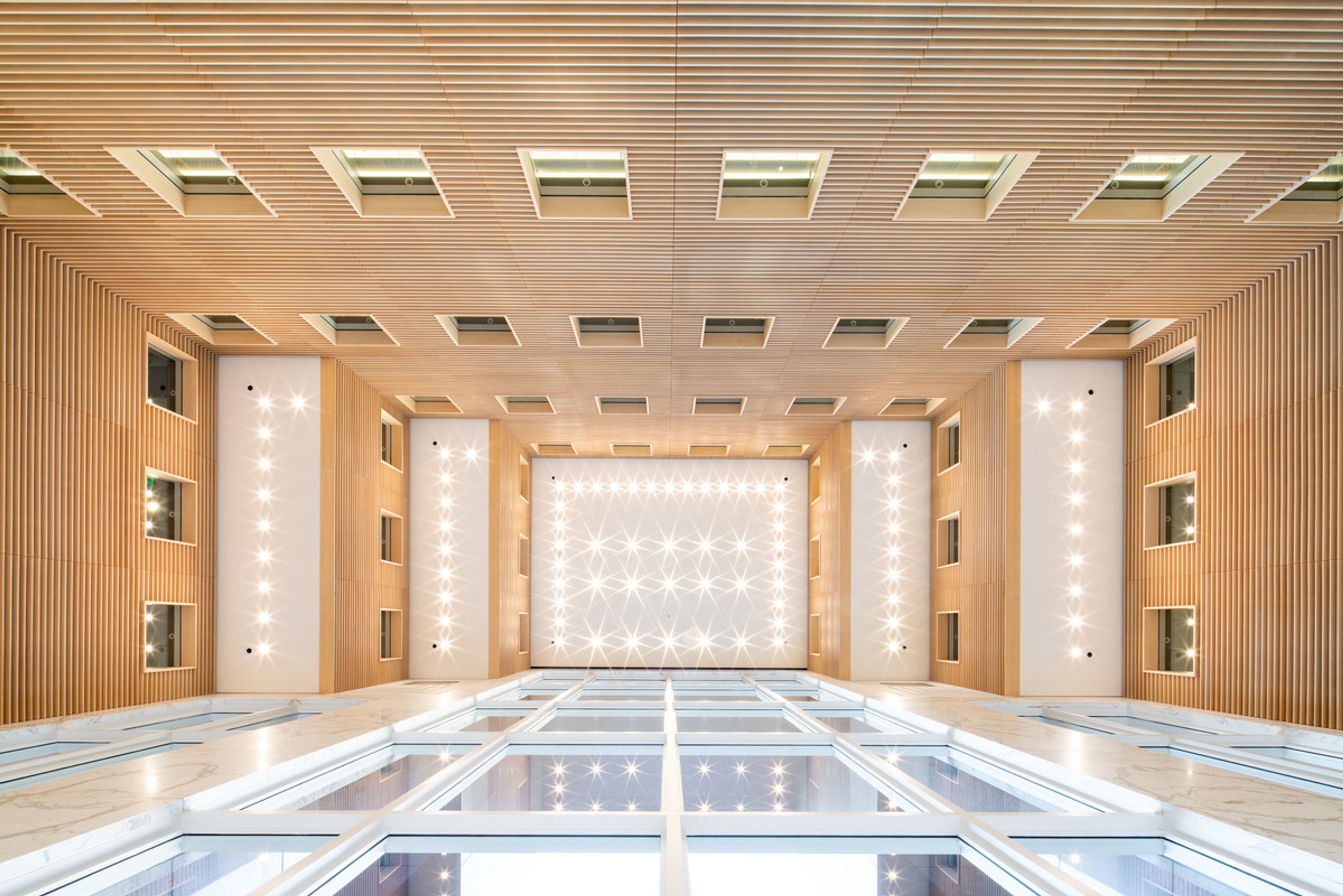View looking up to tall ceiling surrounded by windows