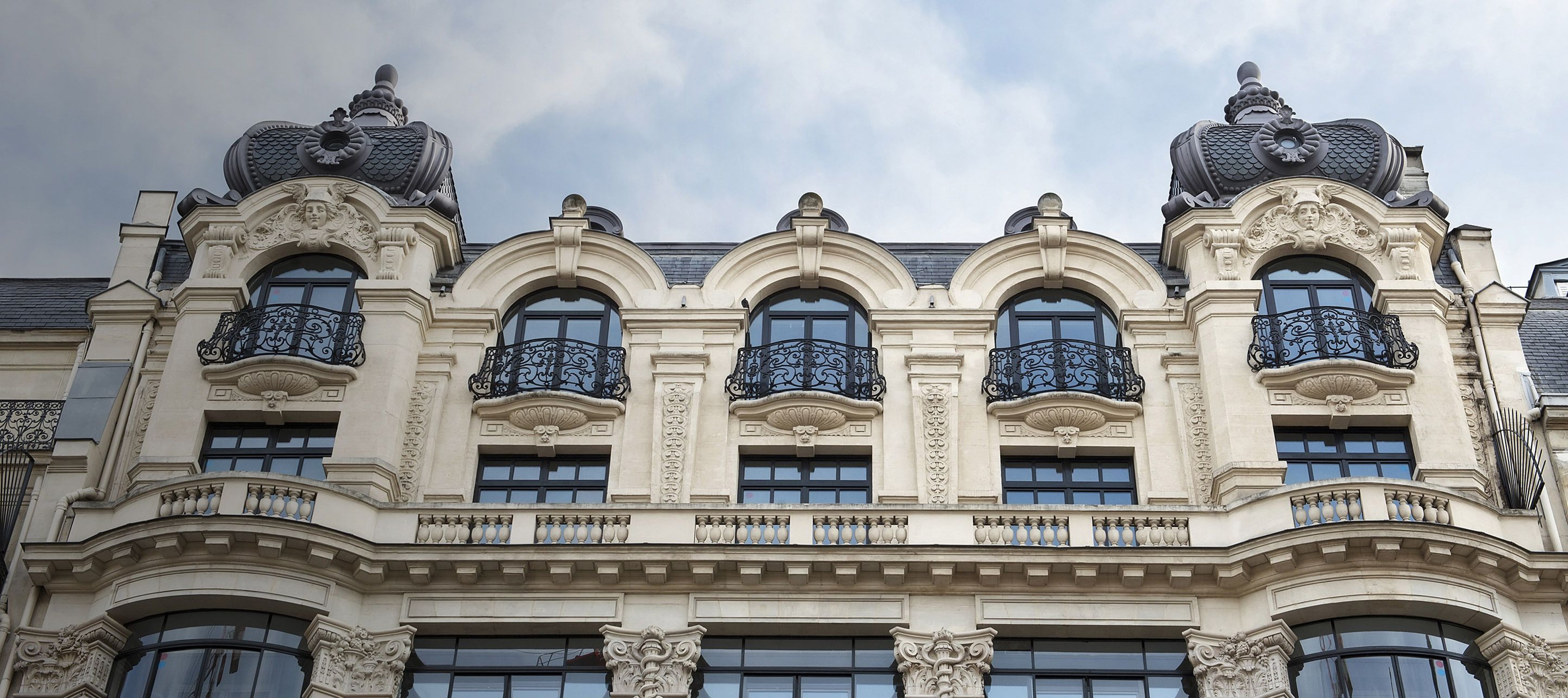 A historic building in Europe, viewed from the ground at a steep angle
