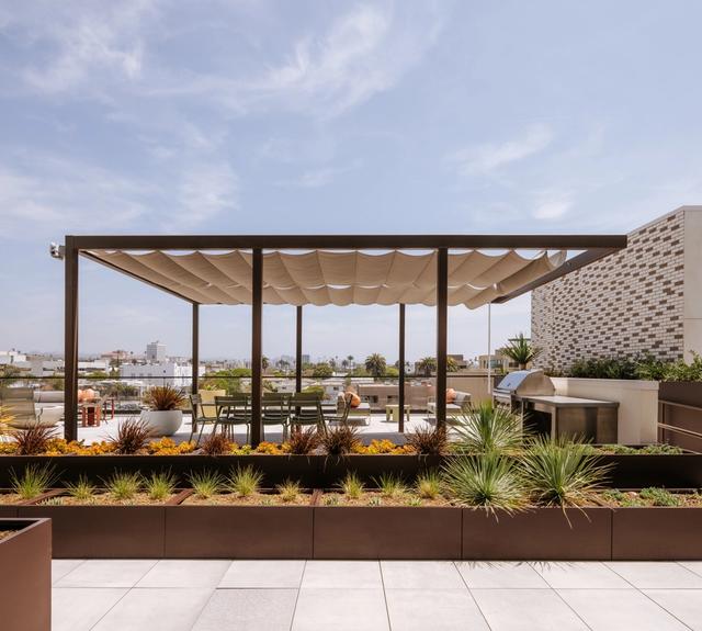 At the heart of the rooftop, barbecue stations offer a simple way to gather over food and sweeping ocean views