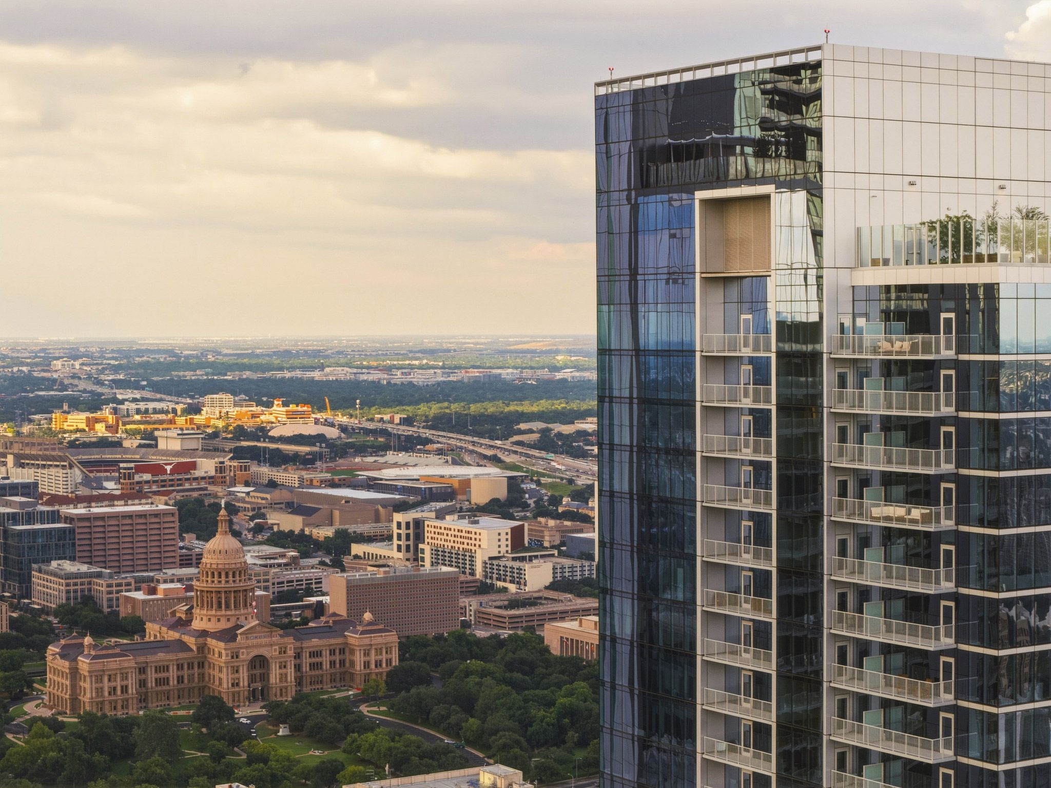 the 44 East Ave Condominiums in Austin, Texas, featuring a sleek glass facade and prominent balconies