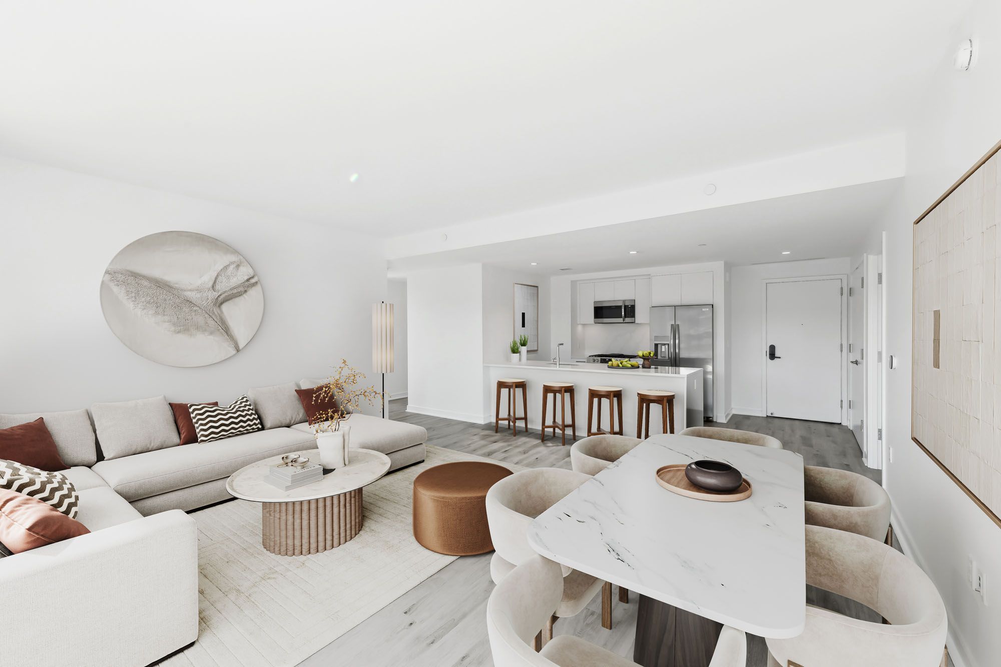 Model living room at Crossing DC apartments in Navy Yard, featuring wood grain floor paneling and white couches.