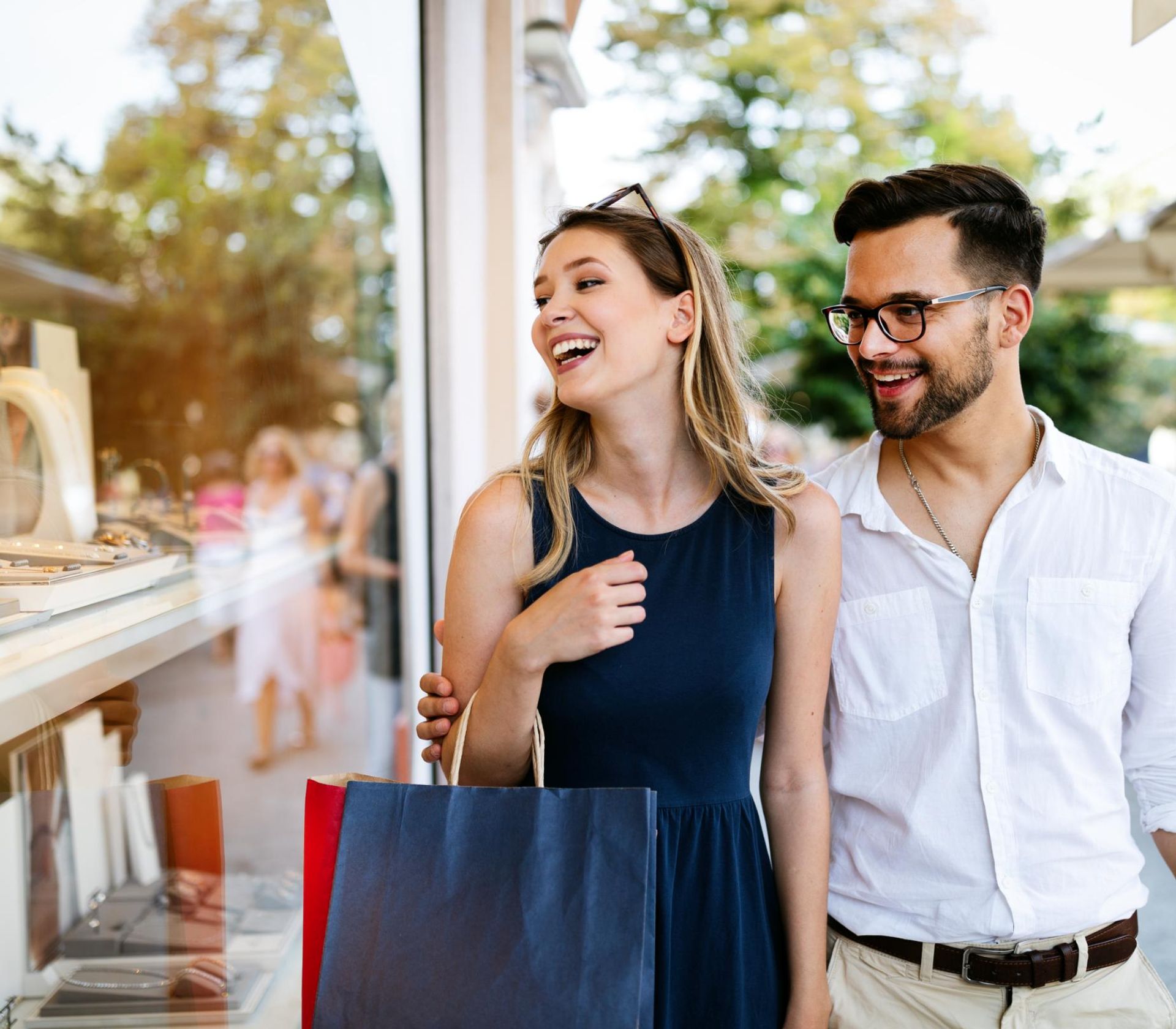 Two people glancing into a boutique shop while walking