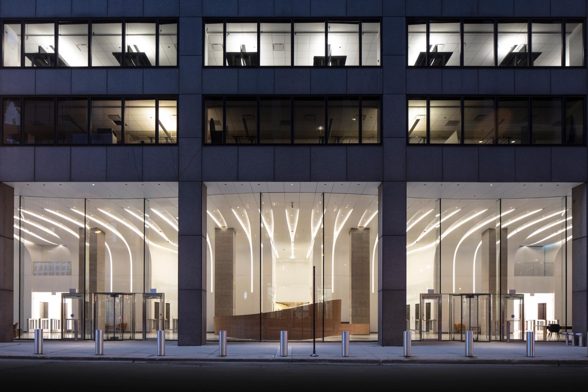 This image shows the modernized lobby of the CME Center at 10 & 30 South Wacker Drive in Chicago, featuring a renovated glass facade.