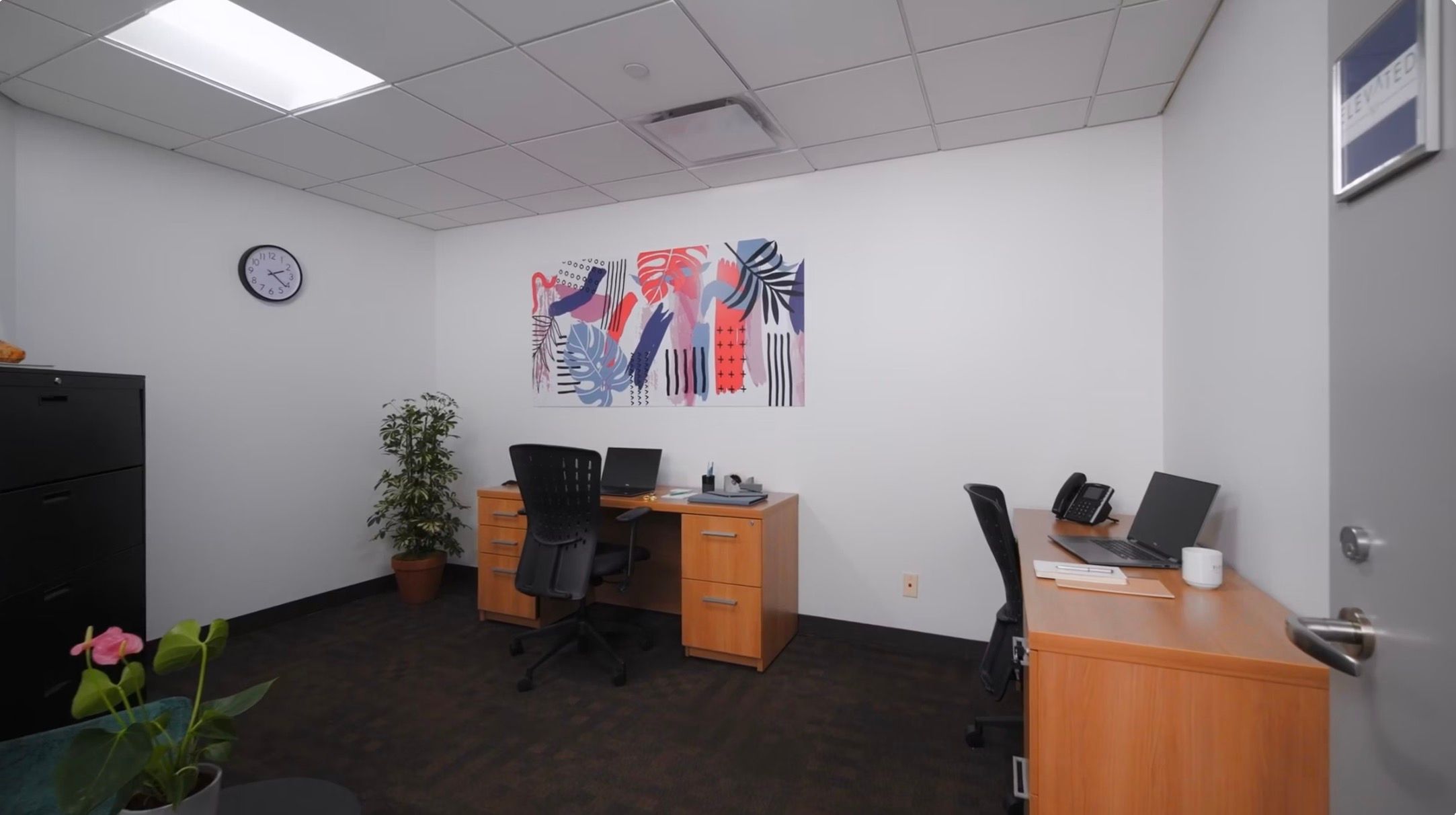 a small, furnished office space that appears to be a serviced or flexible workspace for rent.