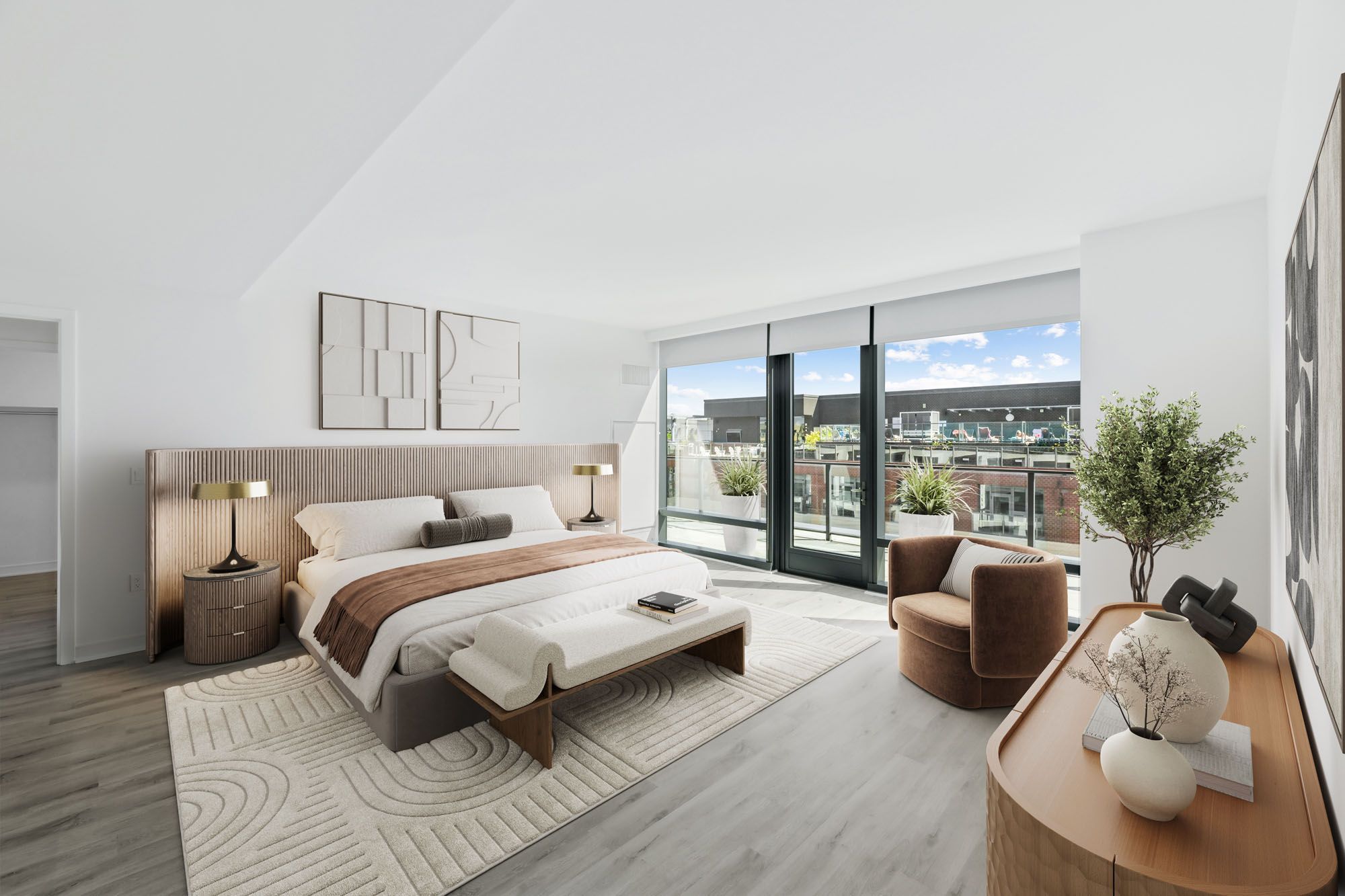 Model bedroom at Crossing DC apartments in Navy Yard, featuring wood grain floor paneling and floor to ceiling windows.