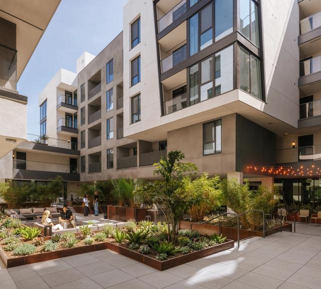 An open courtyard where layered planting and comfortable seating shape a calm retreat