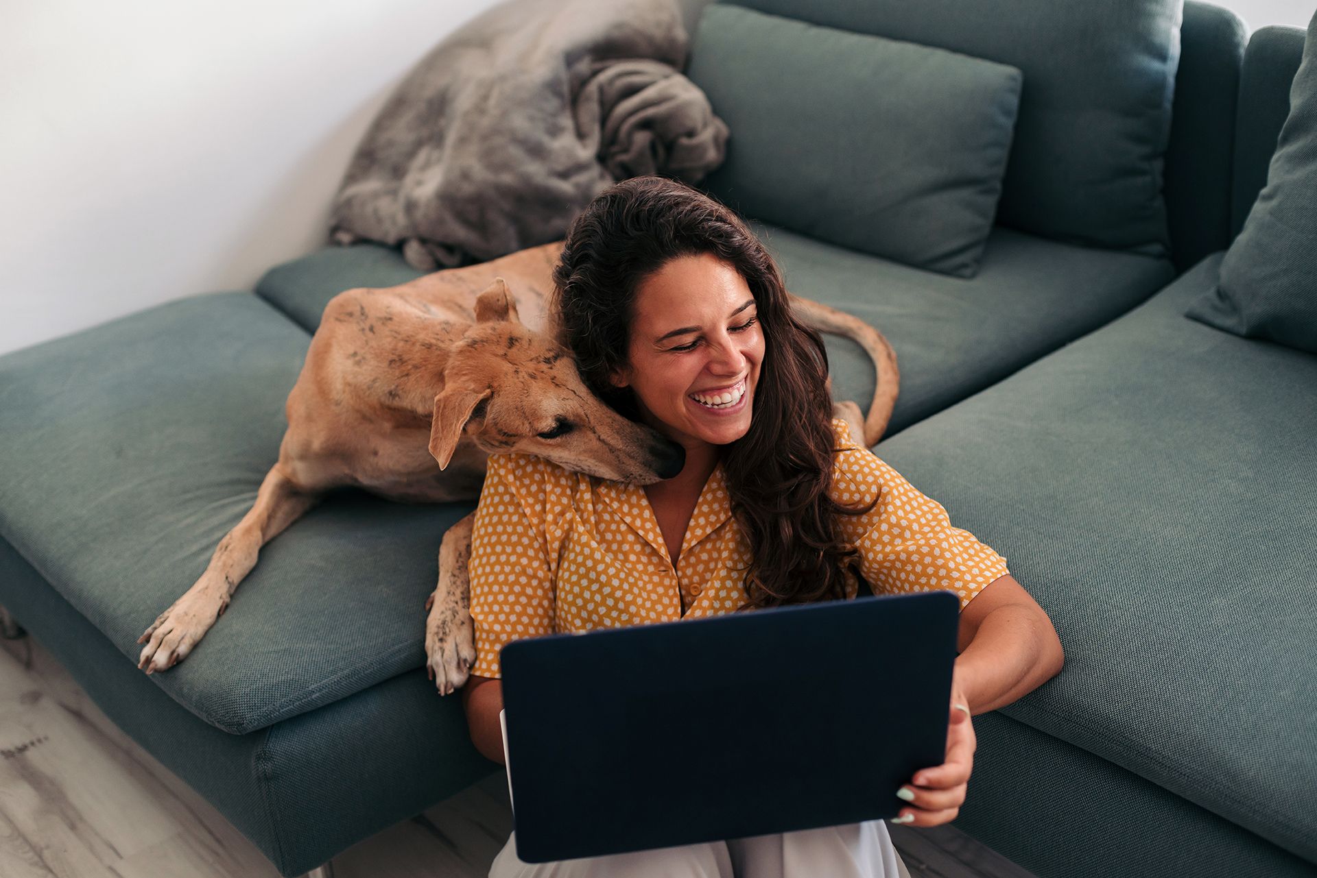 Woman and her dog enjoy time in their Residences at Mazza living room