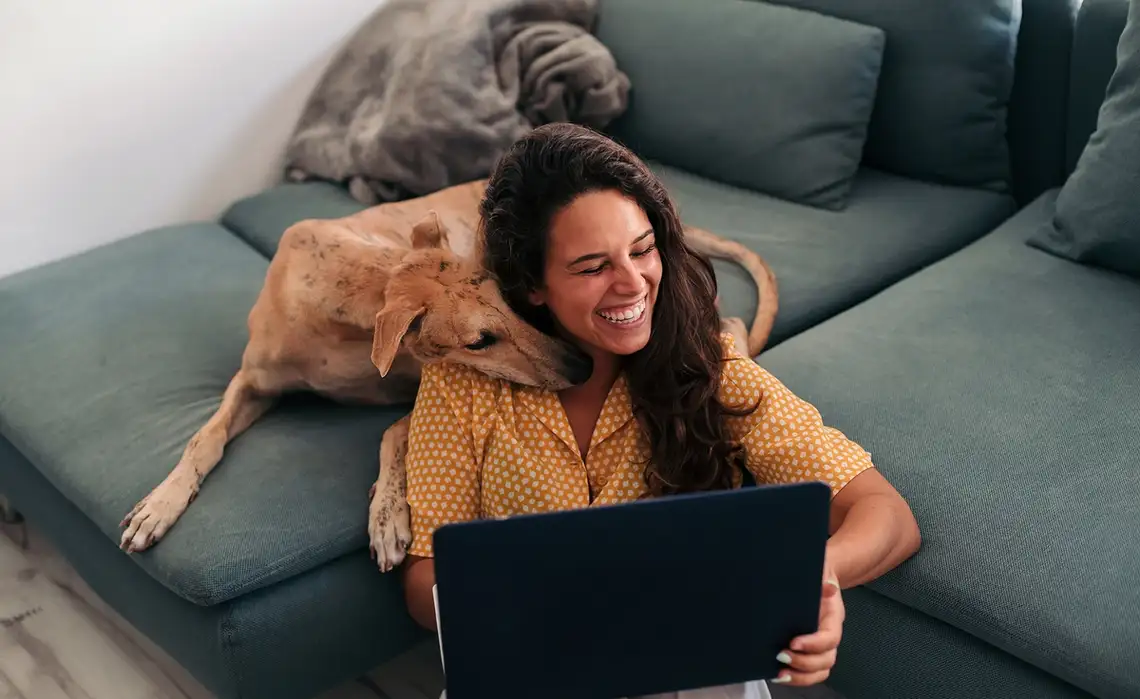 Woman and her dog enjoy time in their Residences at Mazza living room
