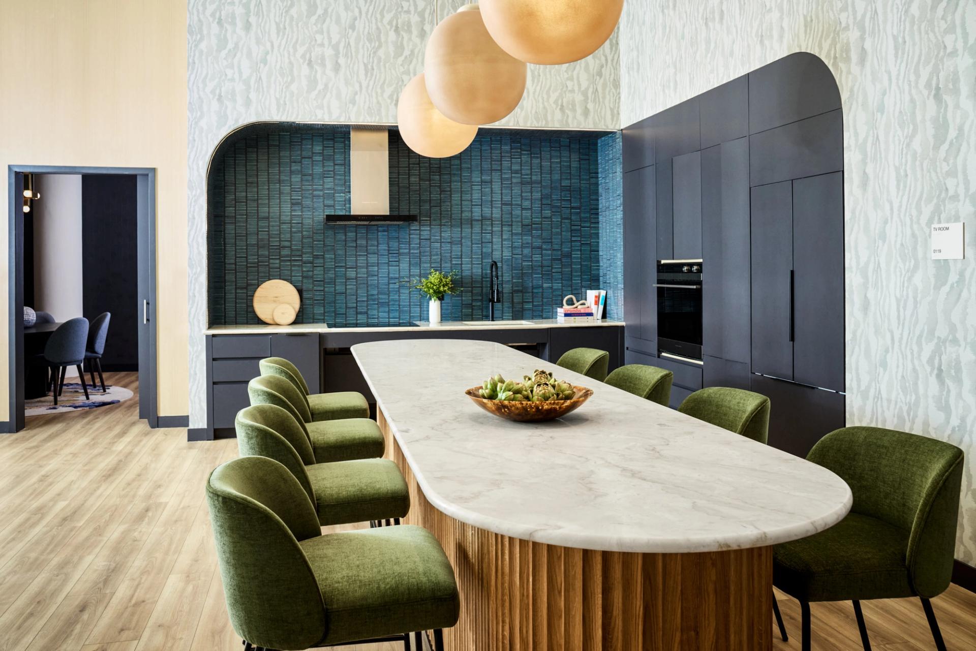 Resident lounge at Verra Apartments for rent in Boston, featuring wood grain flooring and counter seating.