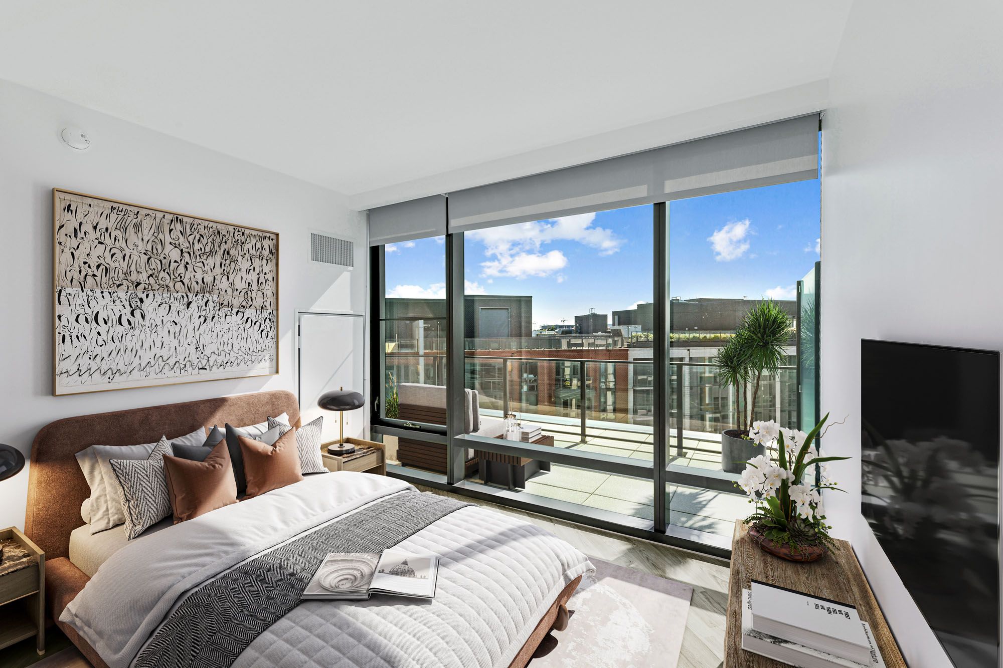 Model bedroom at Crossing DC apartments in Navy Yard, featuring wood grain floor paneling and floor to ceiling windows.