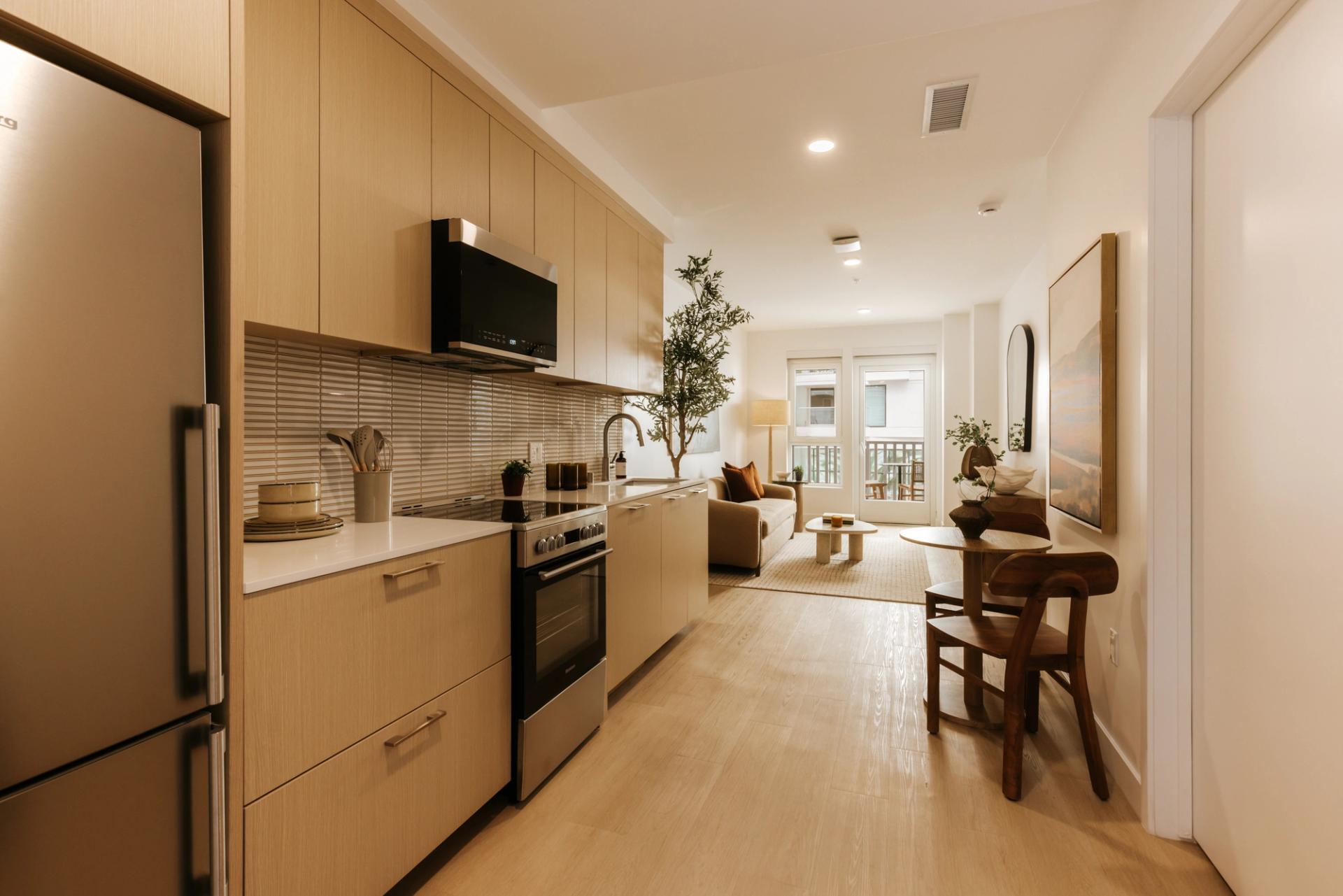 Kitchens with white oak cabinetry, mosaic tile backsplash, and stainless appliances
