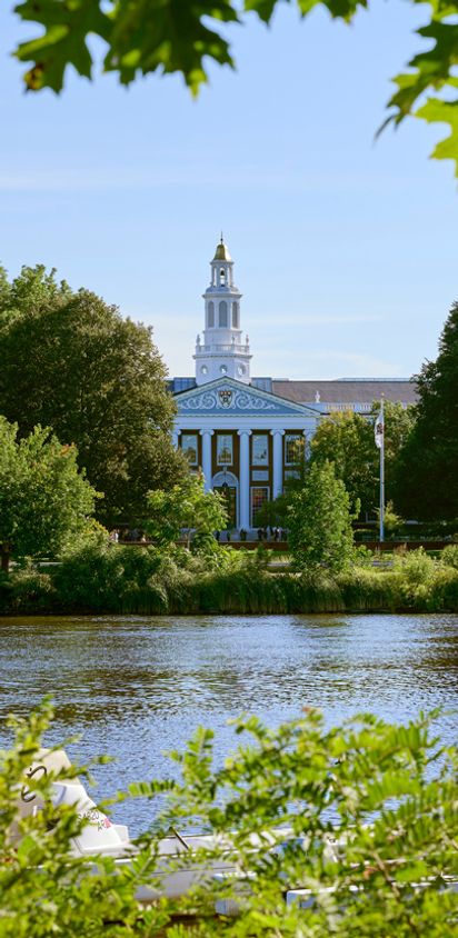 The lagoon and park near Verra Apartments for rent in Boston, MA, featuring a stately building with a bell tower.