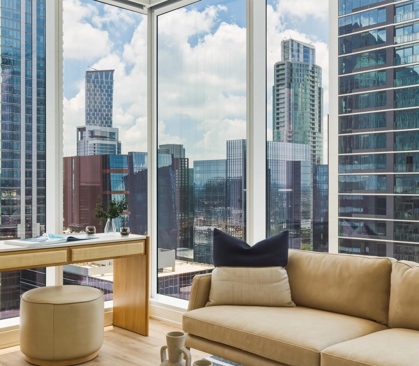 Luxurious bathroom with a view of the balcony and city