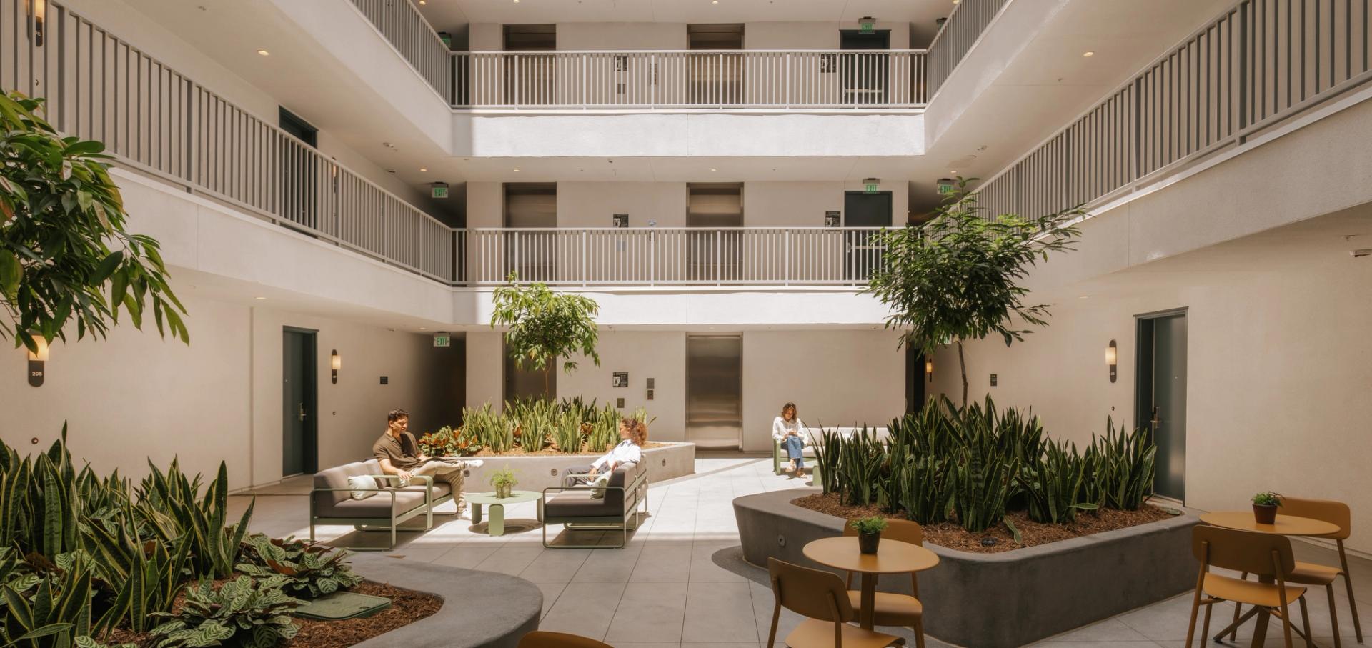 A sun filled courtyard with comfortable seating for coworking, relaxing, or connecting throughout the day