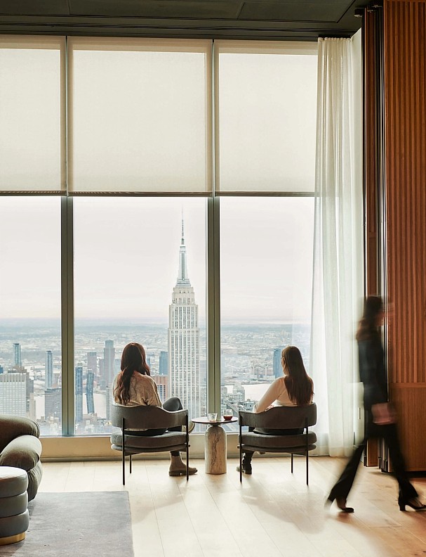 An image of two women sitting by a window