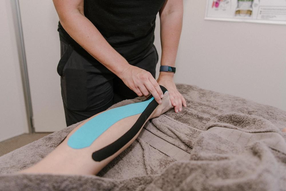 Kinesio Tape on a client's lower leg