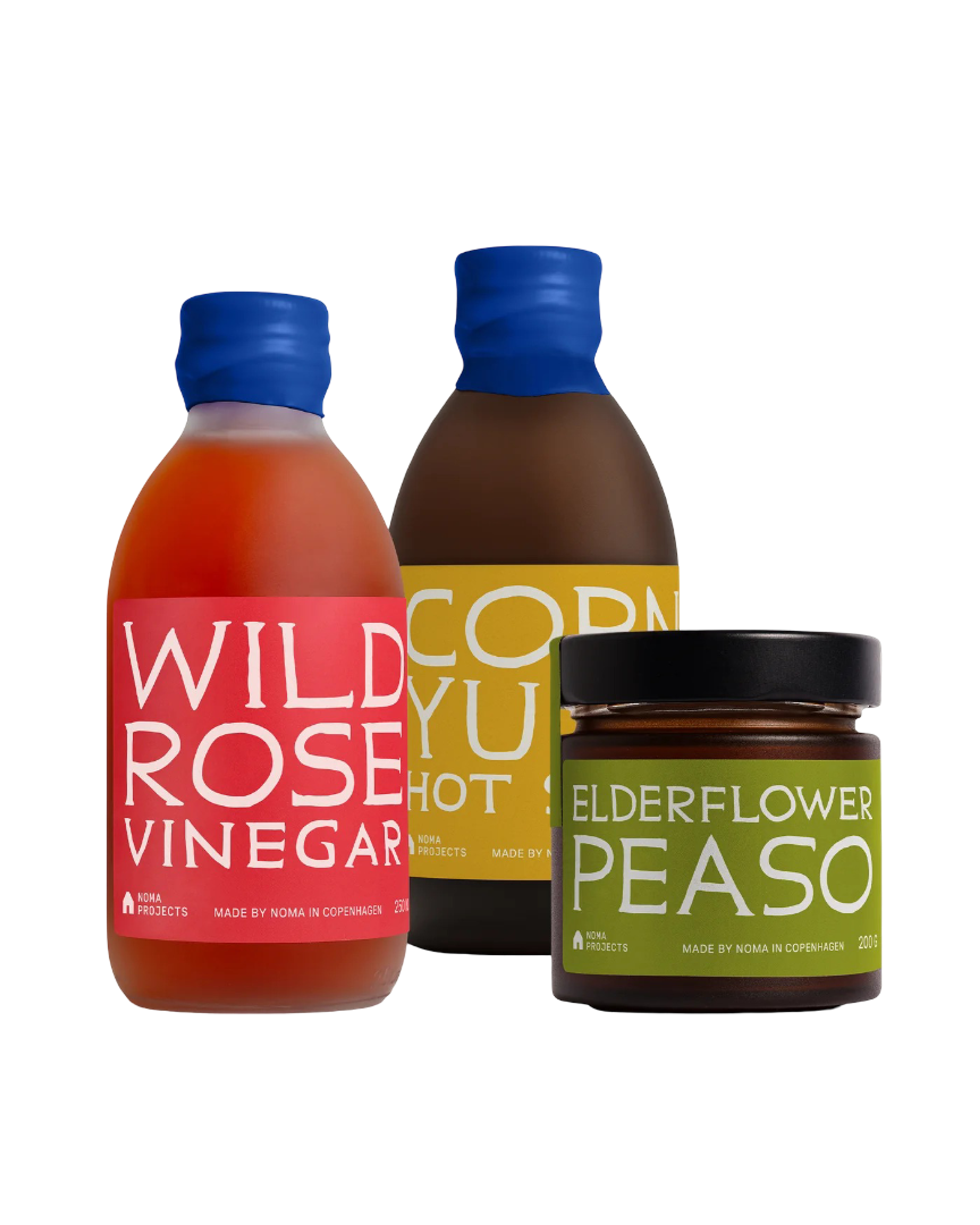 Three jars and bottles featuring vibrant labels: Wild Rose Vinegar, Corn Yuzu Hot Sauce, and Elderflower Peaso.