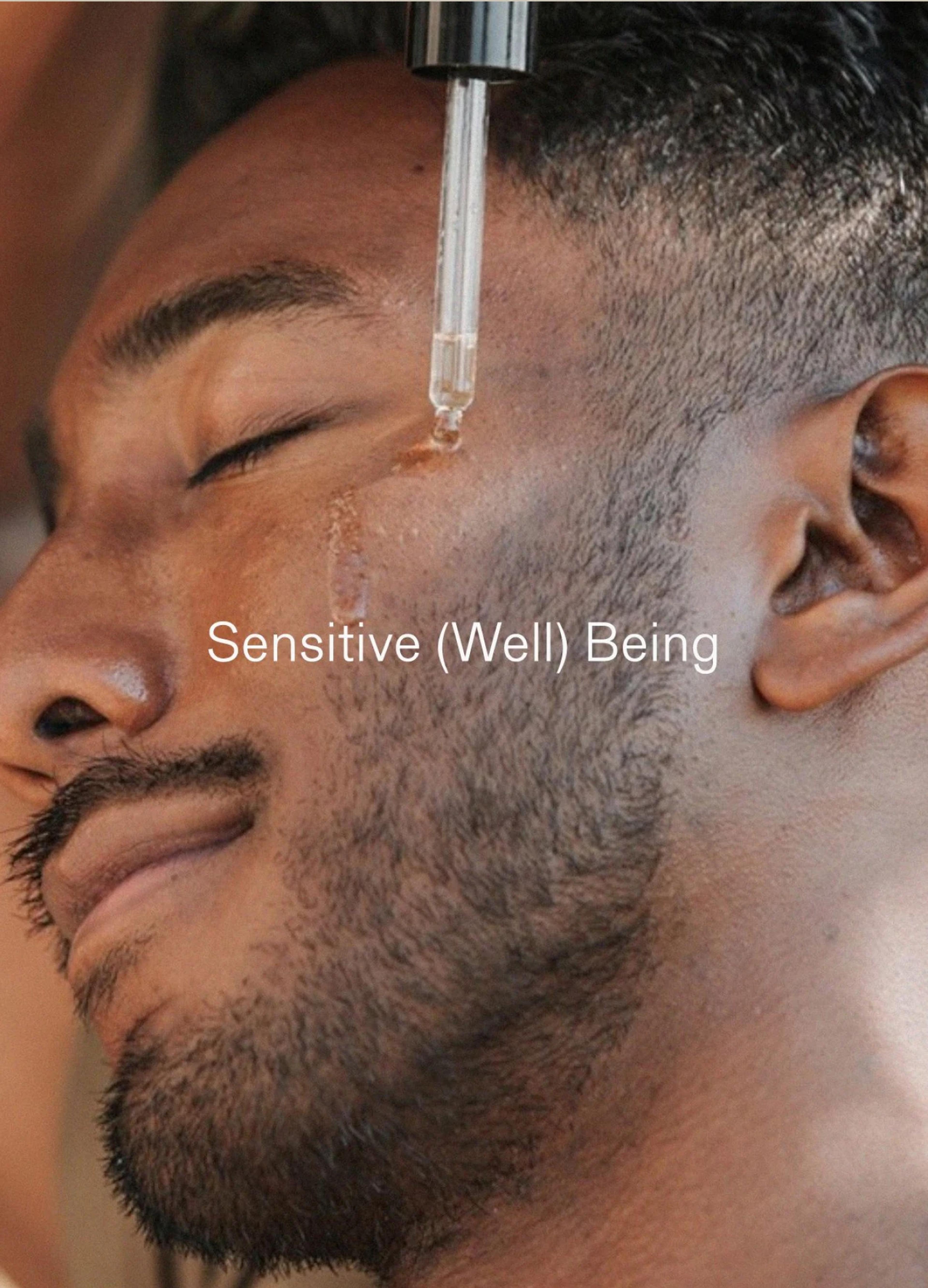 A man relaxes with his eyes closed as a dropper applies a serum to his cheek, showcasing a serene expression.