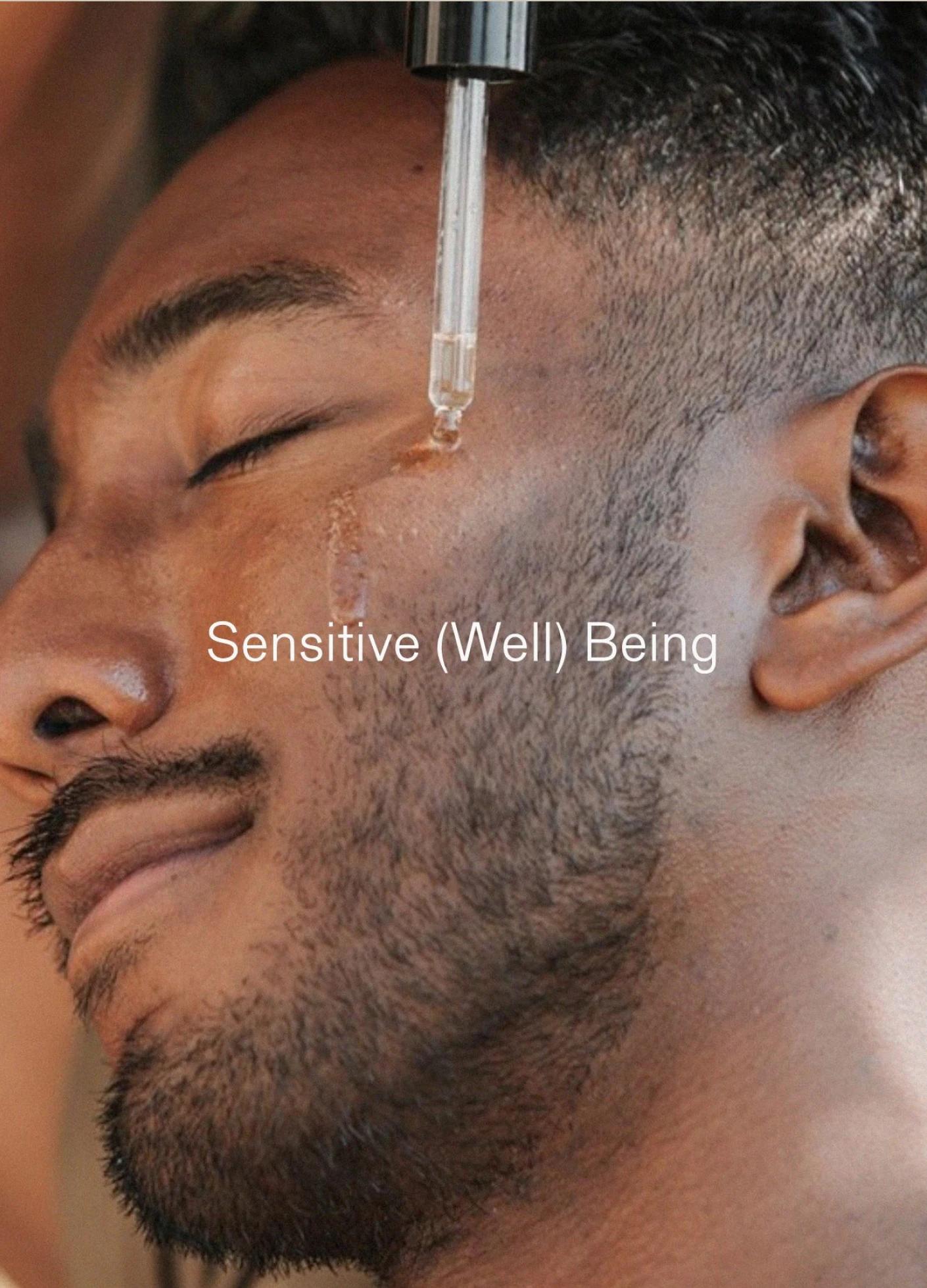 A man relaxes with his eyes closed as a dropper applies a serum to his cheek, showcasing a serene expression.
