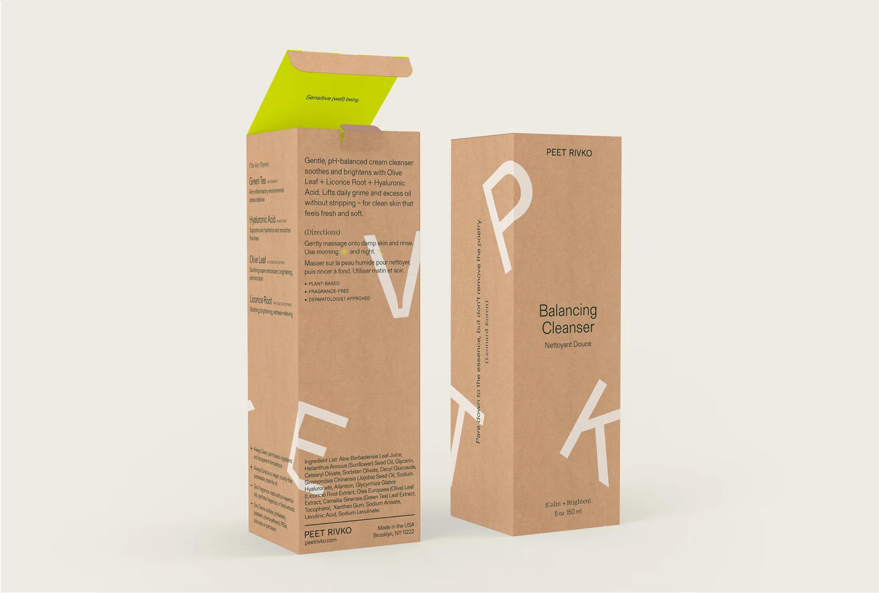 Brown cardboard packaging for Balancing Cleanser features white text and a vibrant green flap, highlighting key ingredients.