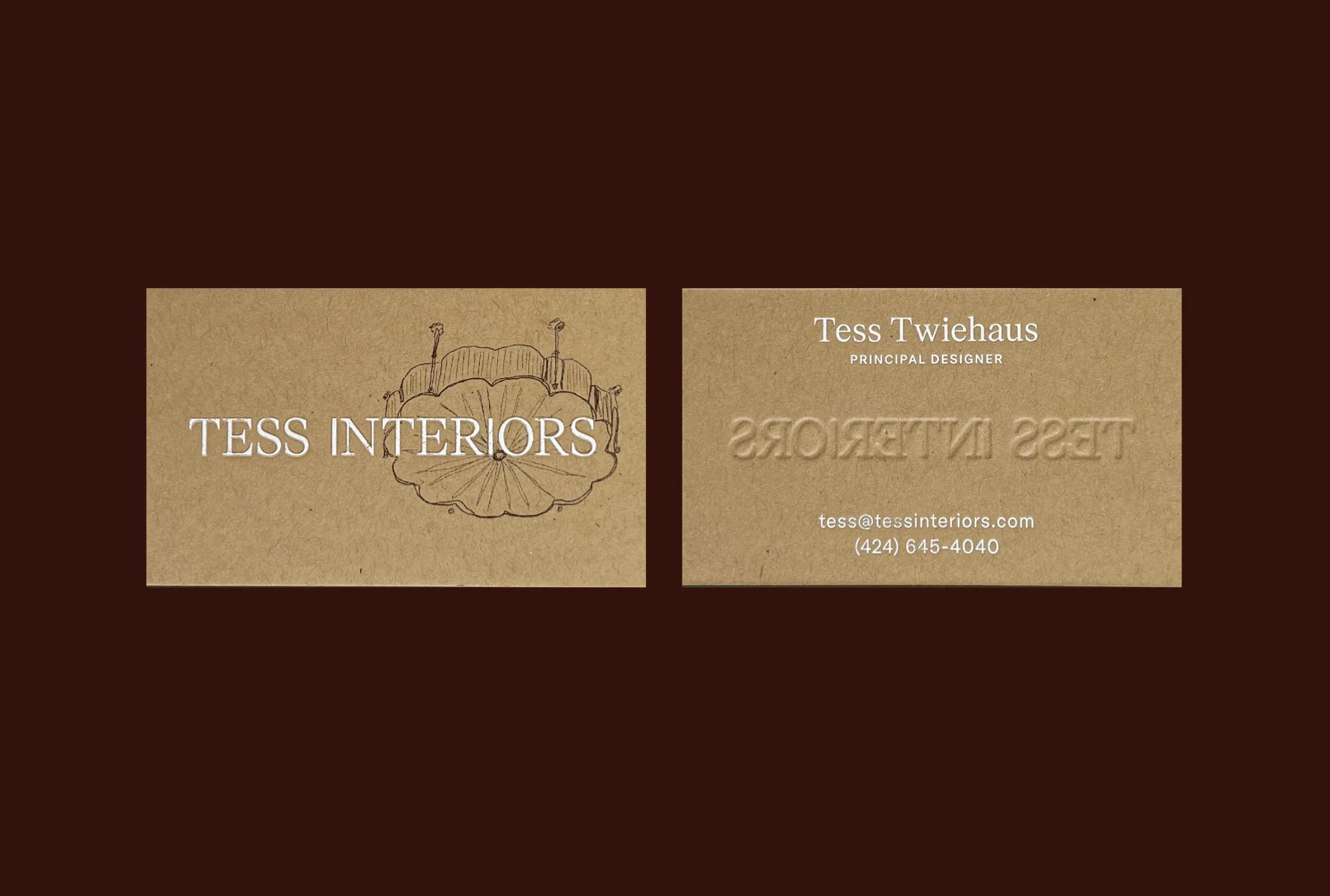 Business card for Tess Interiors featuring the name, contact details, and a decorative light fixture illustration.