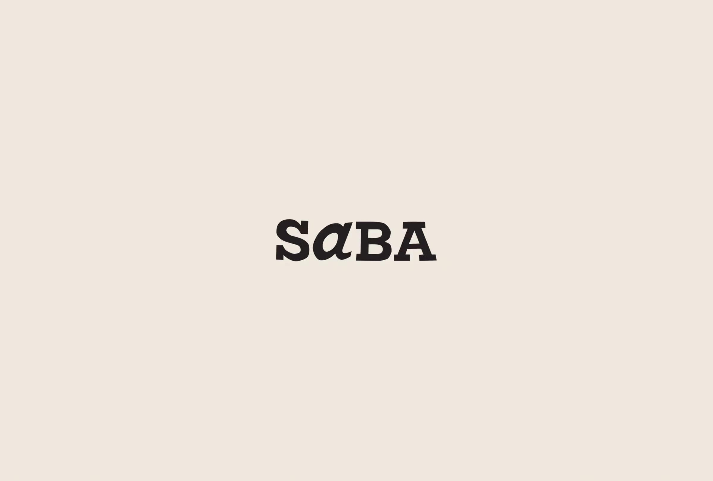 Black text spelling "SABA" on a soft beige background, with the letter 'a' stylized in lowercase.