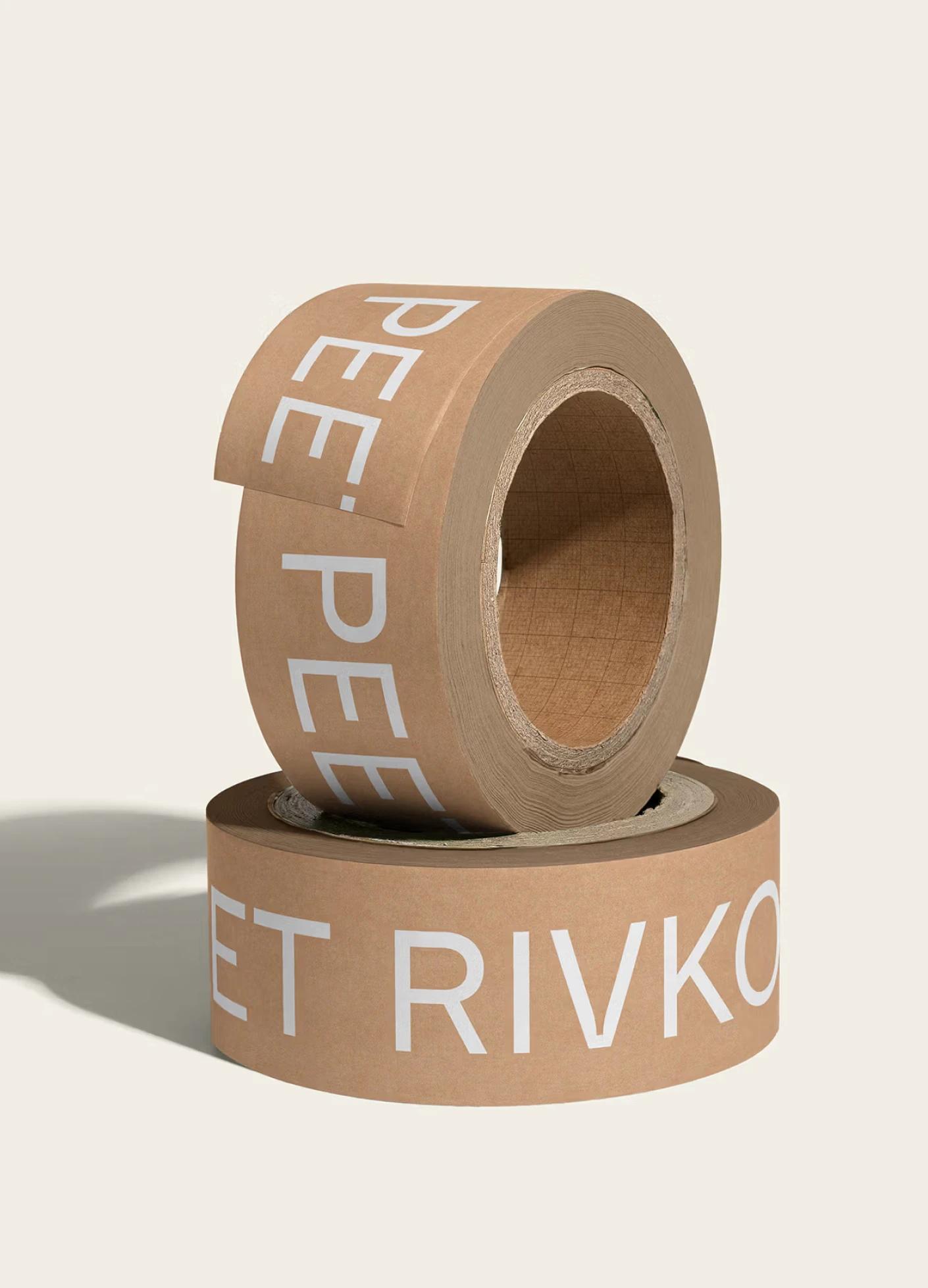 Two rolls of brown tape featuring bold white text, stacked with one partially unrolled, against a light background.