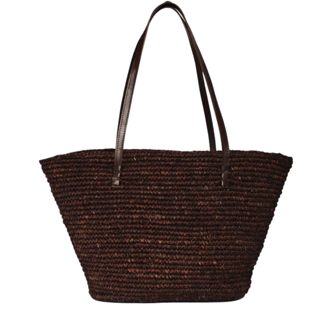 A large, woven brown tote bag with leather handles, featuring a wide, open design and a textured surface.