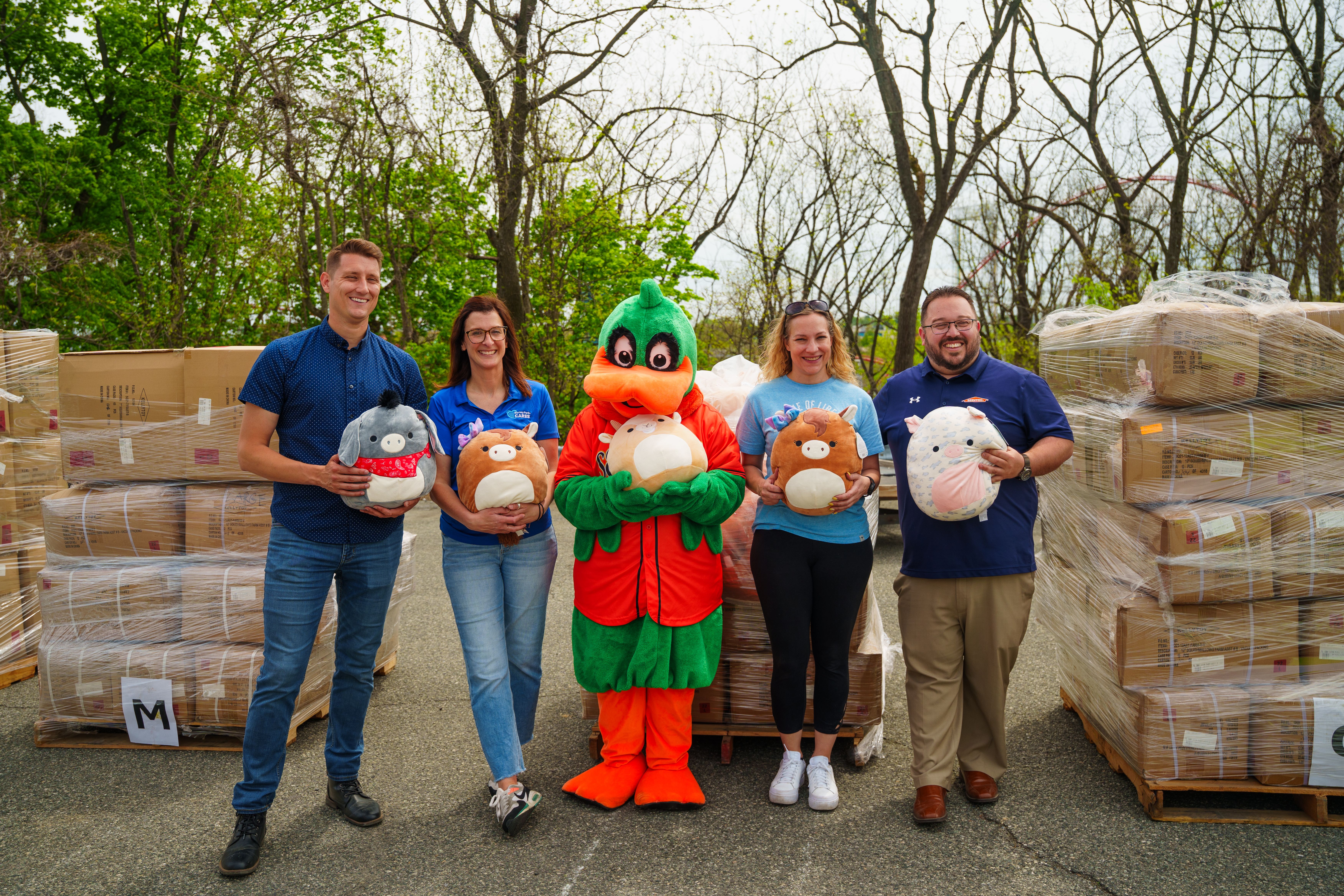Dorney Park, Emily's Hug Mee Drive, HeroBuds Lehigh Valley, and SERVPRO partners pose with Squishmallows and donation boxes