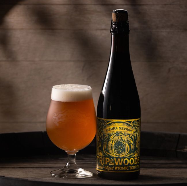 Sierra Nevada Trip In The Woods Atomic Torpedo, poured into a balloon glass next to the bottle.