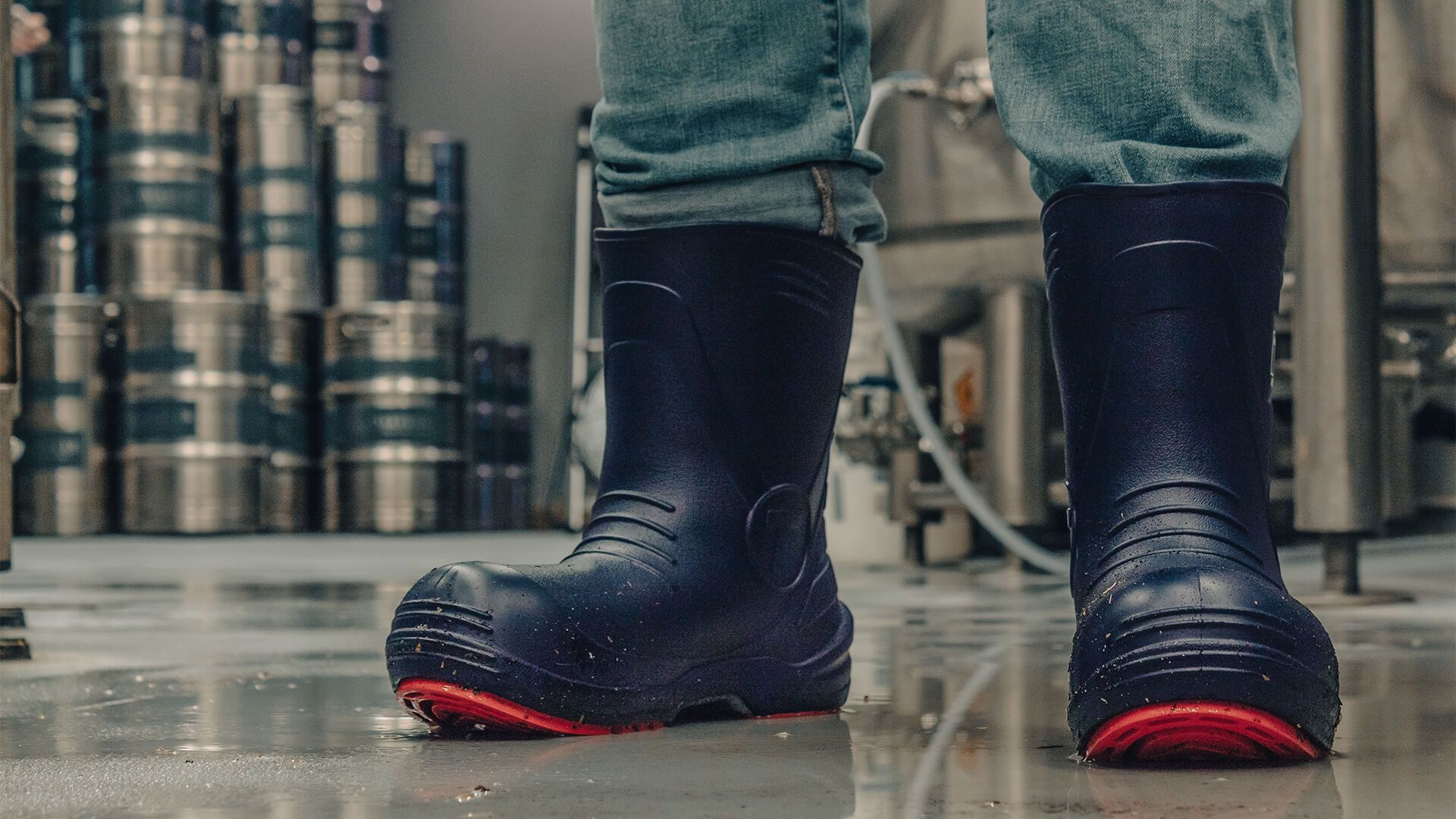 man wearing boots in brewery