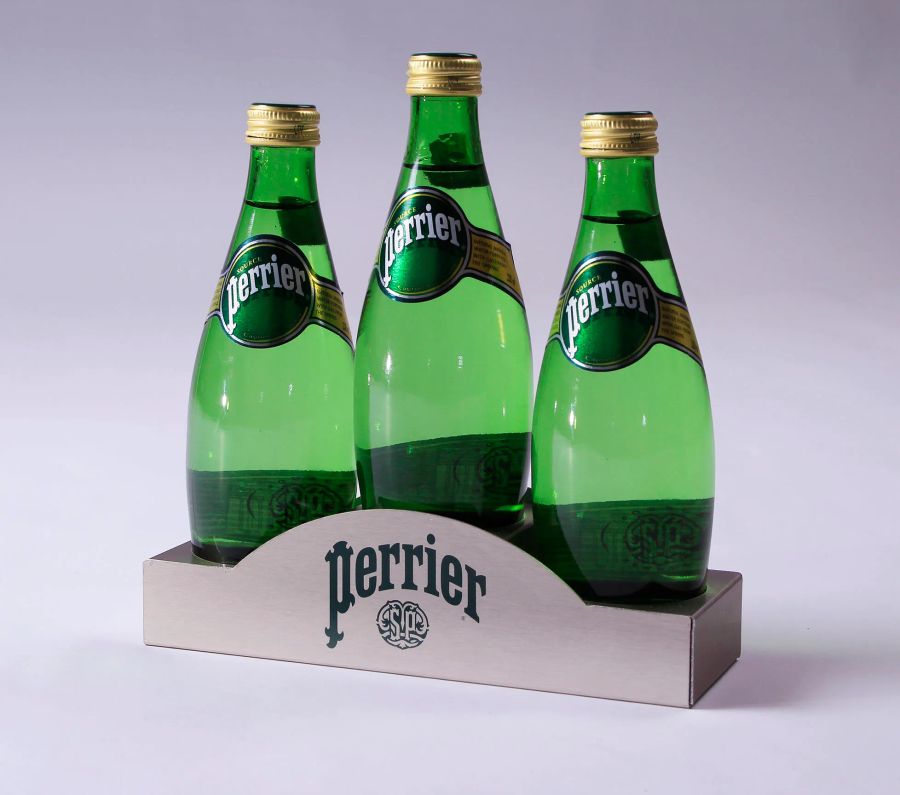 Three Perrier bottles in metal glorifier stand