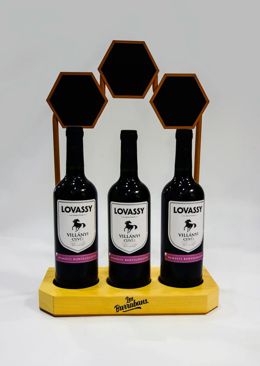 Three wine bottles on wooden glorifier stand