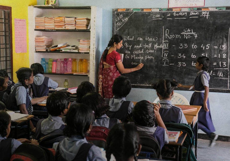 A teacher and pupils taking part in a classroom lesson