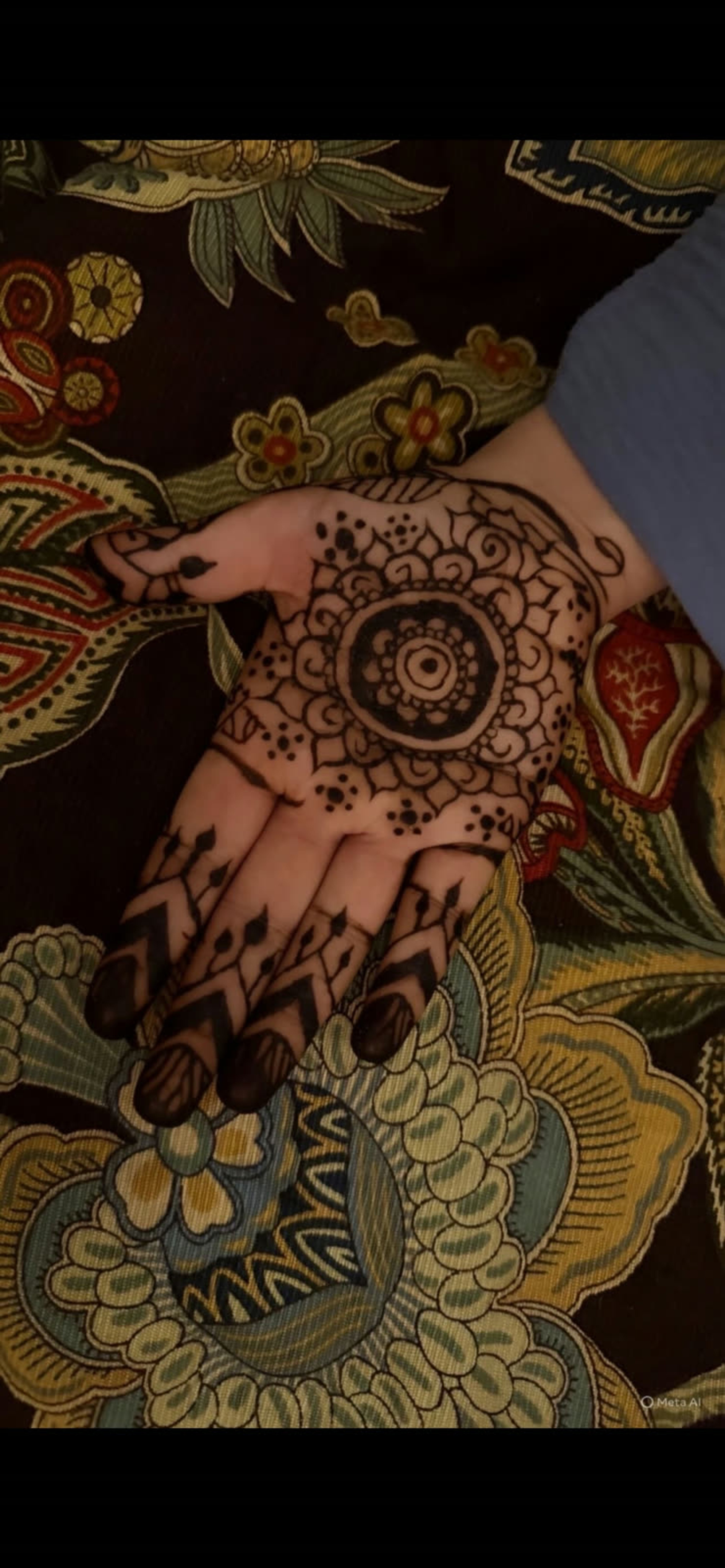 Natural henna mandala worked across the palm