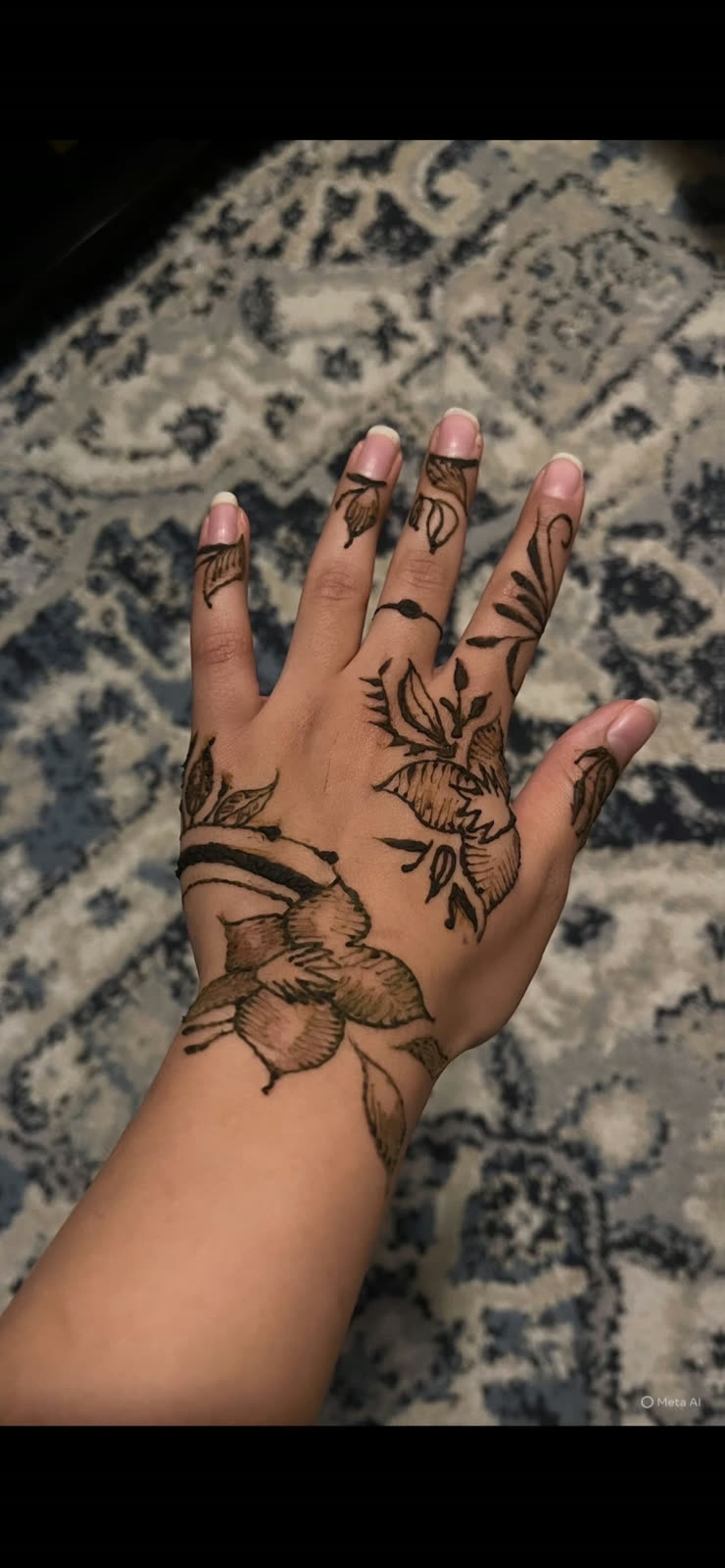 Natural henna florals running along the hand and wrist