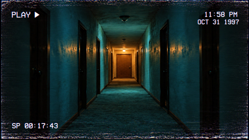 An empty nighttime corridor with PLAY, a timestamp and VHS tracking noise