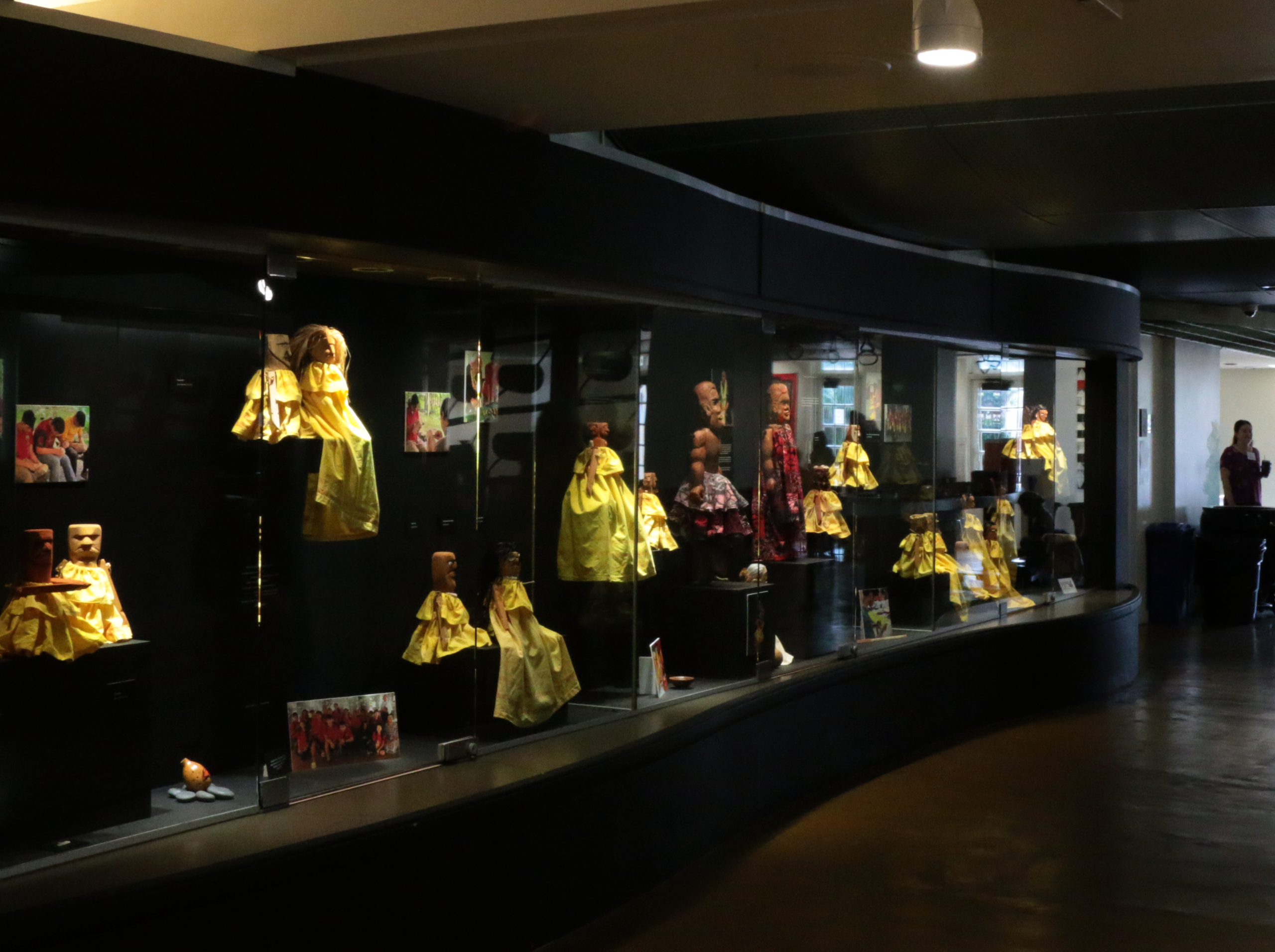 Two people observe artwork in a gallery