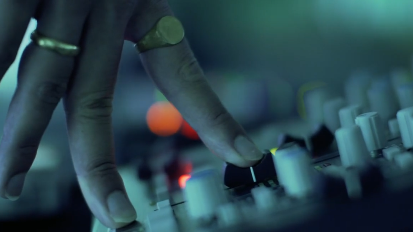 persons hand on a sound board