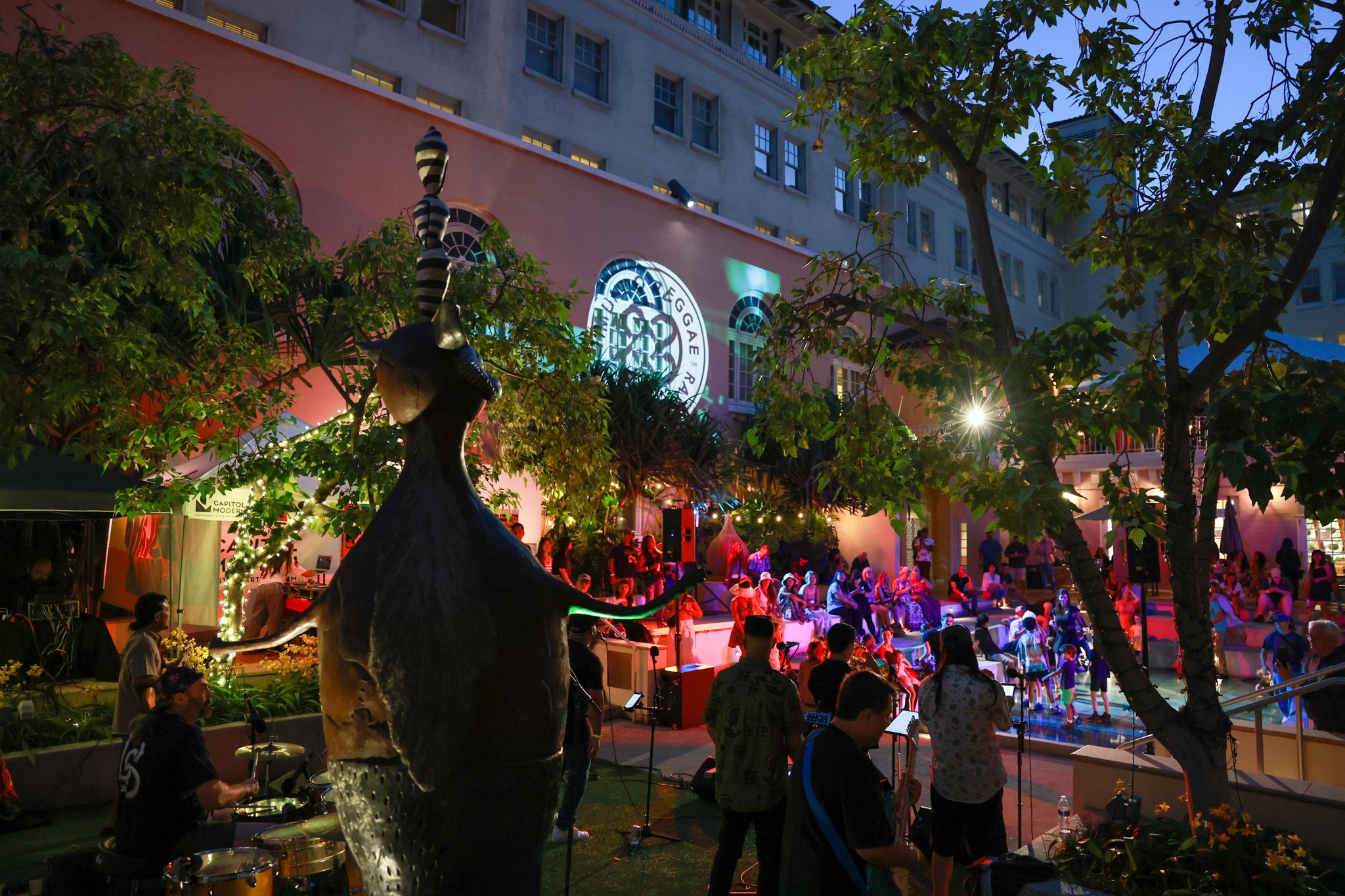 Performers and audience in outdoor space.