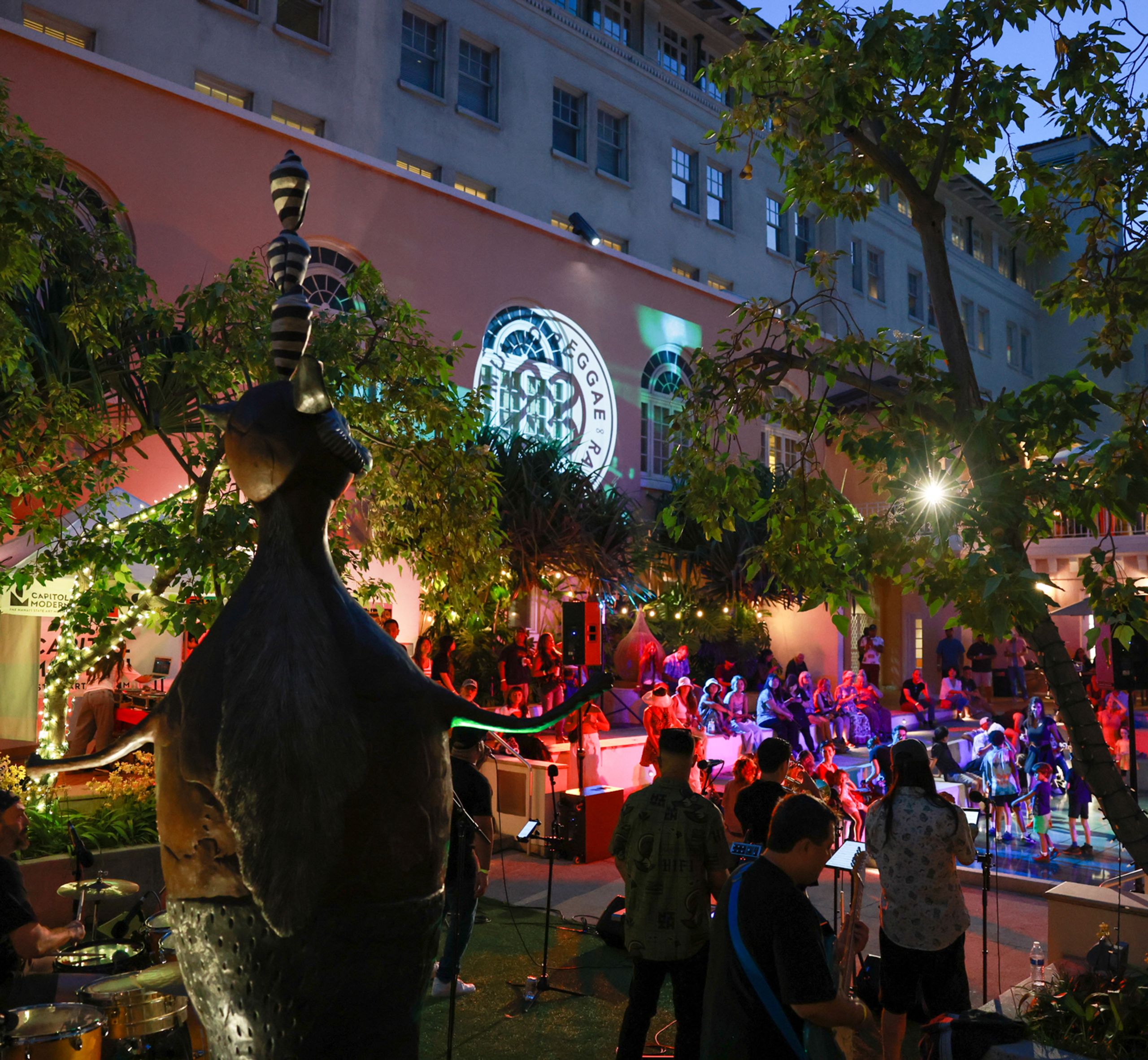 Performers and audience in outdoor space.