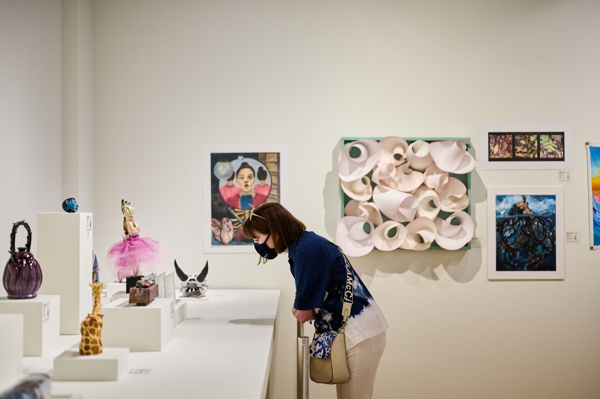 Two men looking at art work in an art gallery.