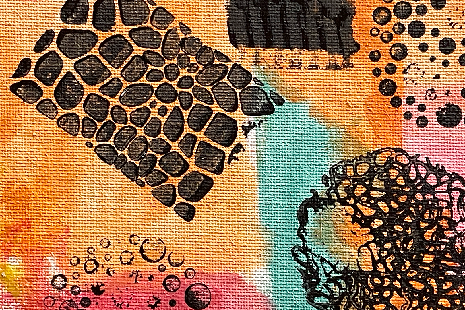 Detail from a painting done with splashes of watercolor in shades of orange, pink, turquoise, and red with patterns stamped over it in black.