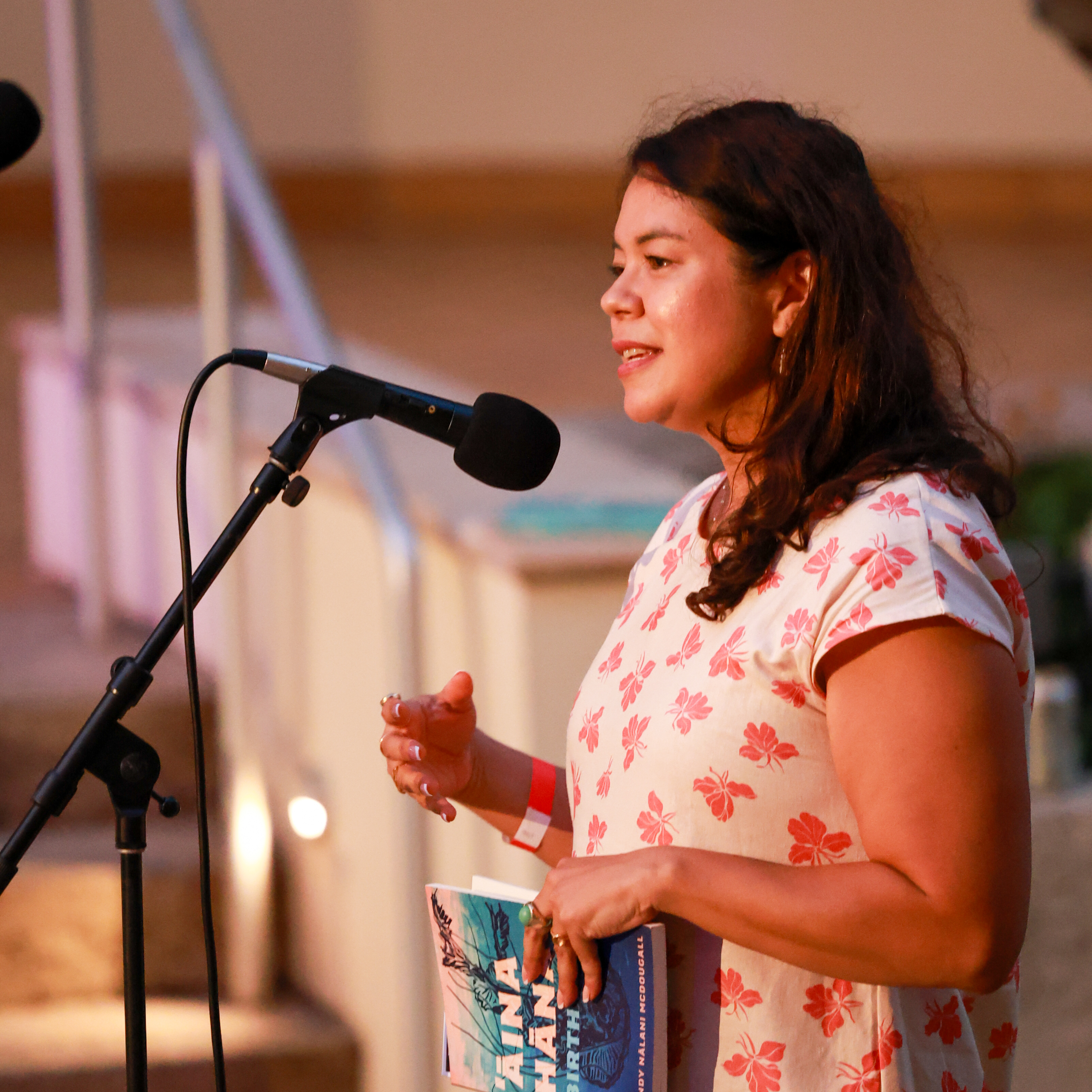 Person standing behind a microphone