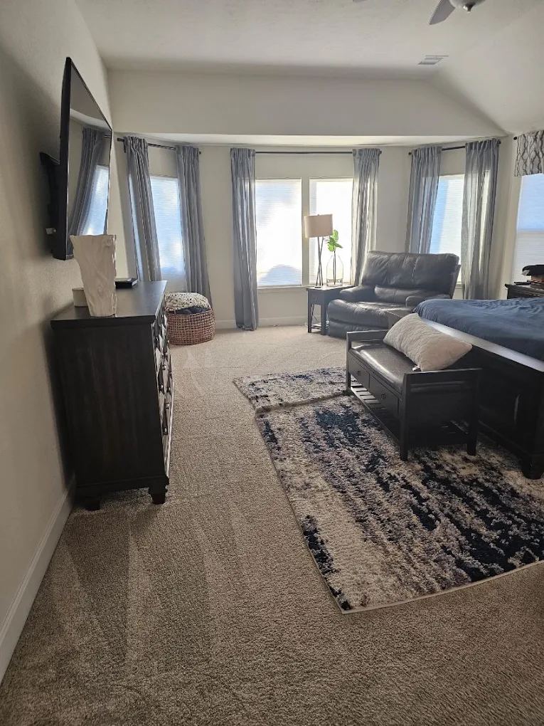 Living room freshened with carpets vacuumed and surfaces dusted