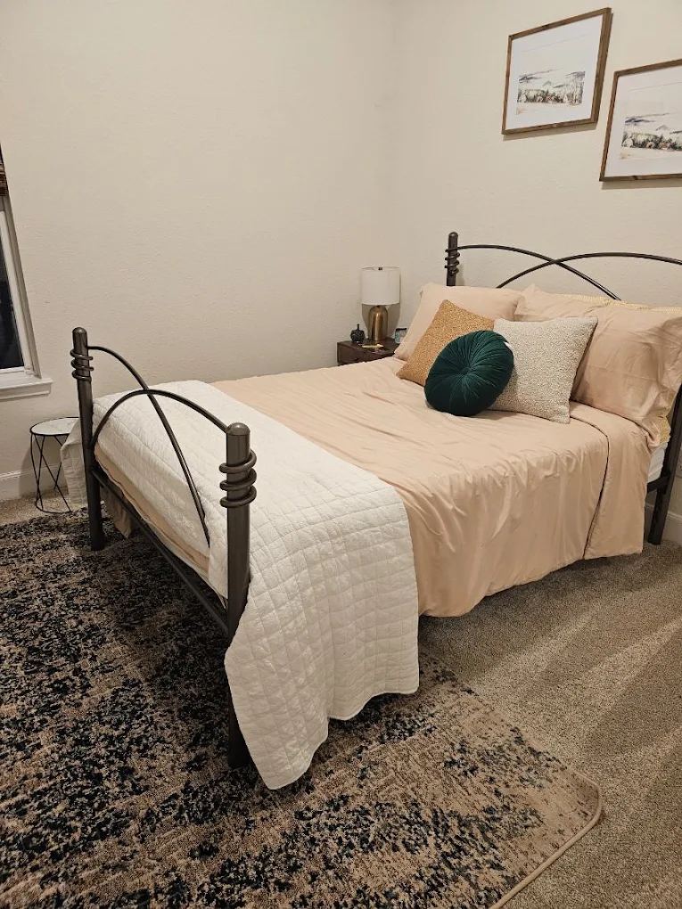Bedroom made up fresh with linens and dust-free surfaces