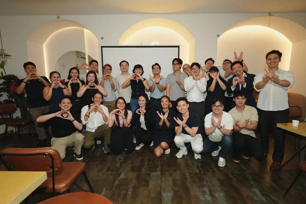 A group of members making hearts with their hands