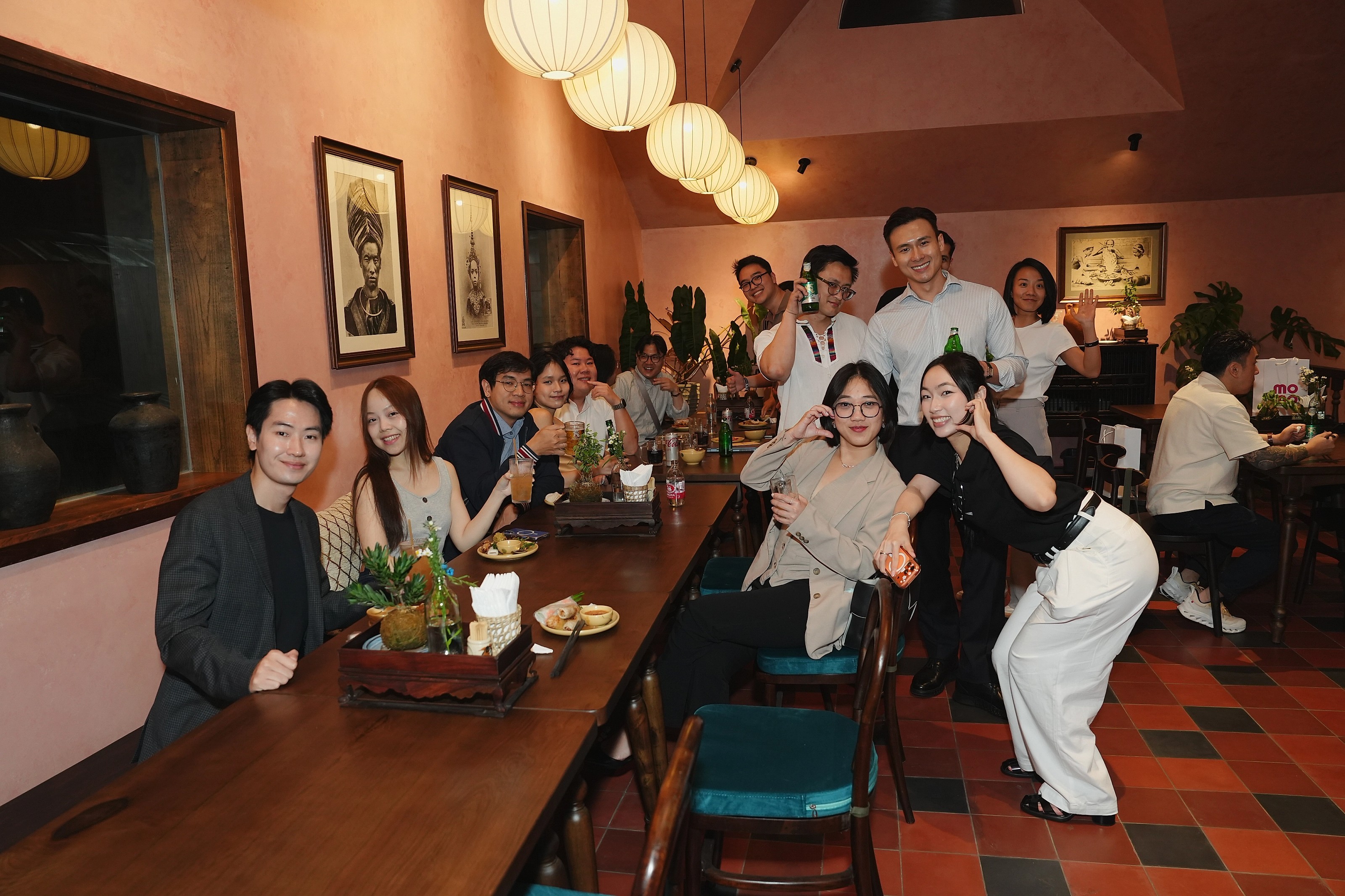 Members raising their glasses at a long dinner table