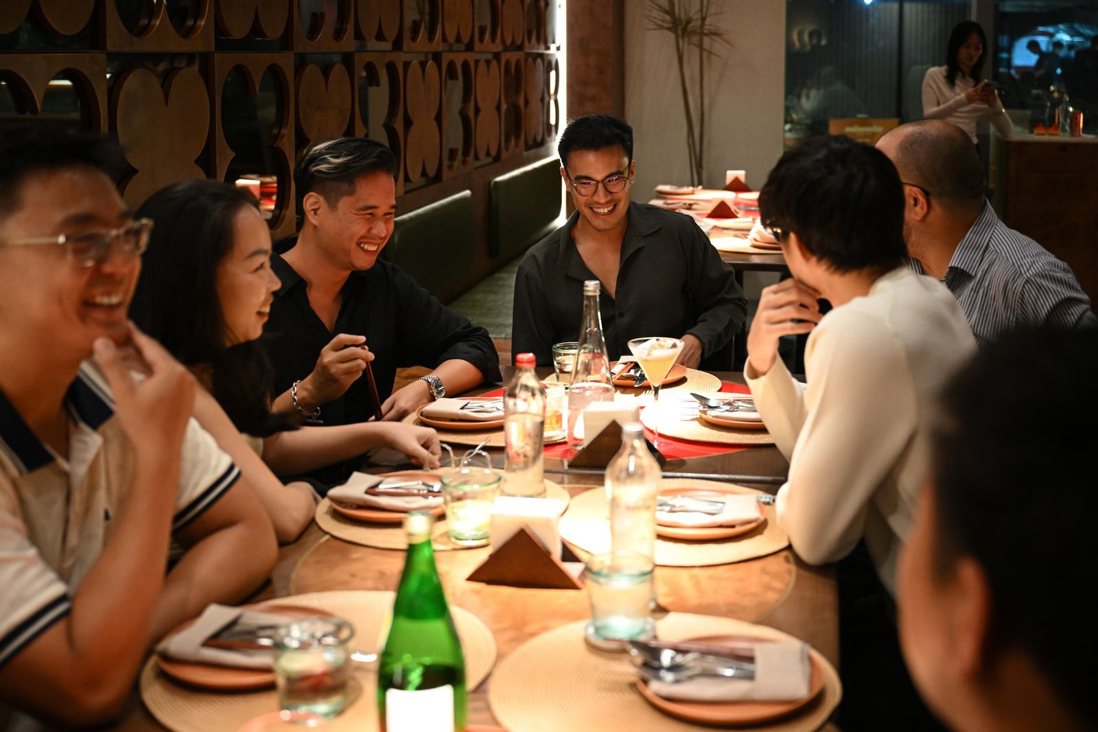 Members laughing around a dinner table